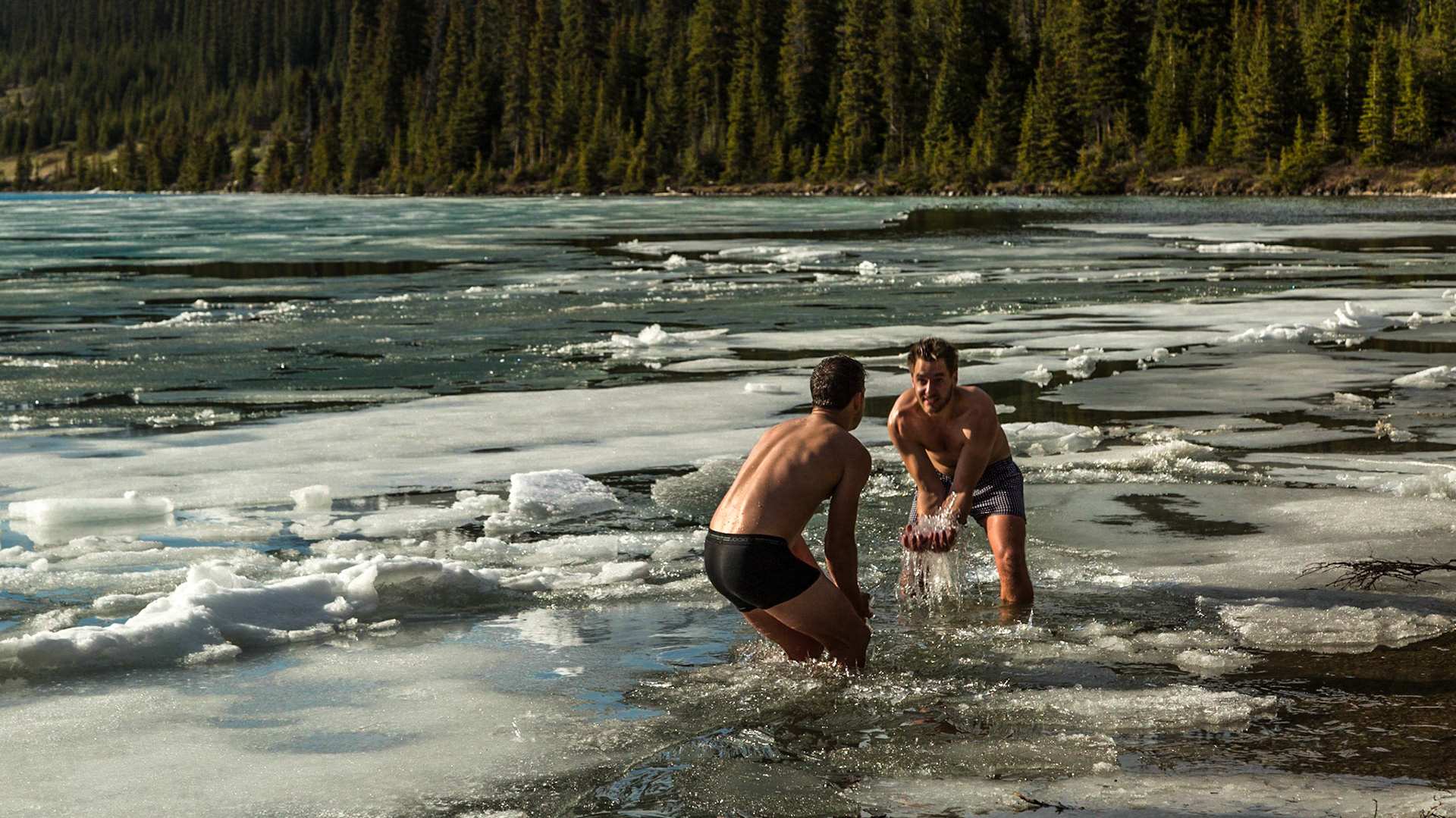Back in the car, after a few shots at the Bow Lake overlook, Mark said “the Norwegian Polar is in the water down there” - pointing toward a beach area. We needed to see more.  It was five or six guys.  The language they used most seemed to be something like German.  A couple of them could communicate with us in English.  And, they were stripped to their undershorts – boxers or otherwise.  Apparently, they had all been into the water.  Two were still playing with the ice.  Others were taking pictures and said it was alright for us to shoot.  There was a neatly folded and piled set of cloths near me - except the underwear.