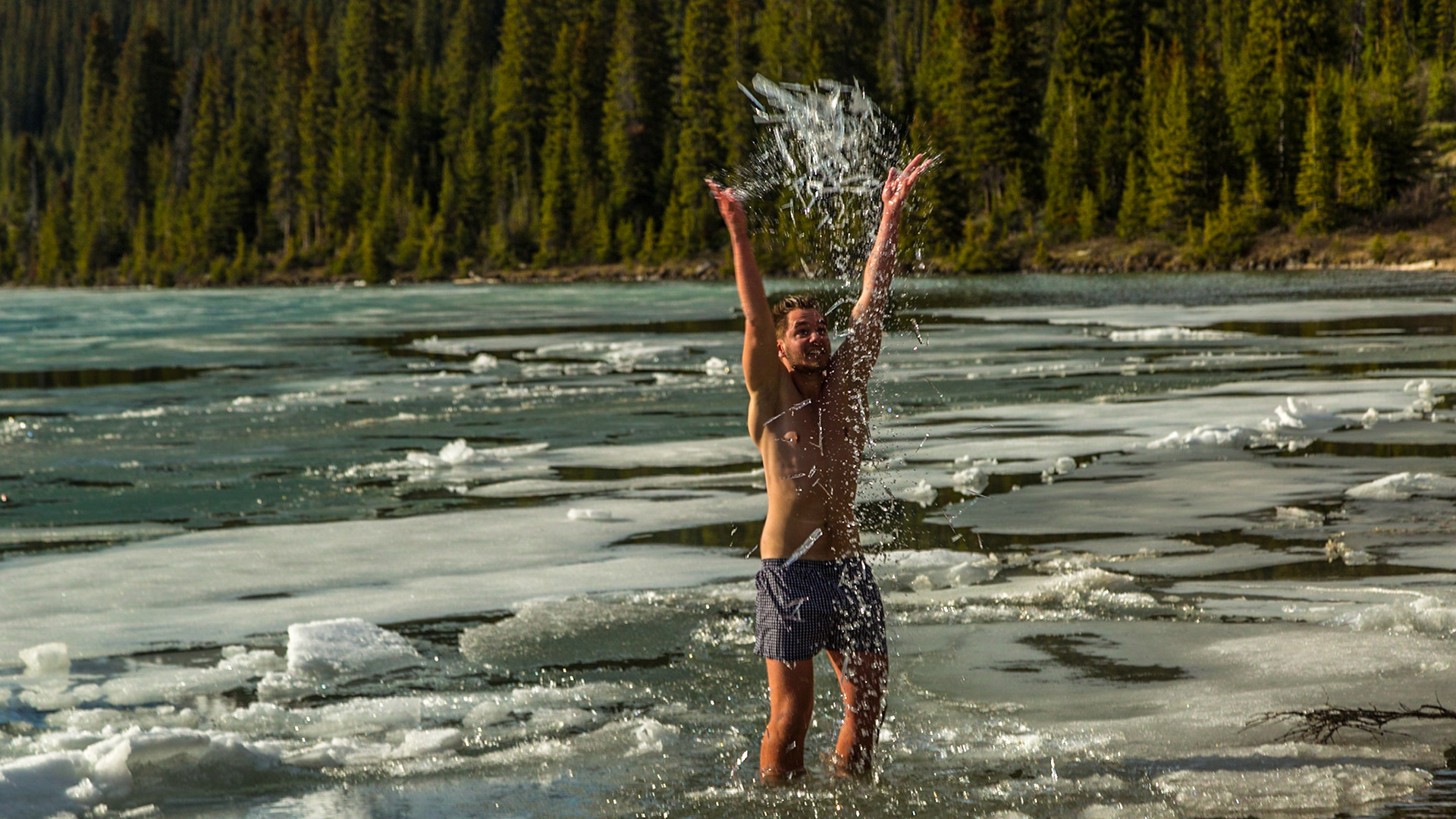 Back in the car, after a few shots at the Bow Lake overlook, Mark said “the Norwegian Polar is in the water down there” - pointing toward a beach area. We needed to see more.  It was five or six guys - probably in their 20’s.  The language they used most seemed to be something like German.  A couple of them could communicate with us in English.  And, they were stripped to their undershorts – boxers or otherwise.  Apparently, they had all been into the water.  Two were still playing with the ice.  Others were taking pictures and said it was alright for us to shoot.  There was a neatly folded and piled set of cloths - except the underwear.