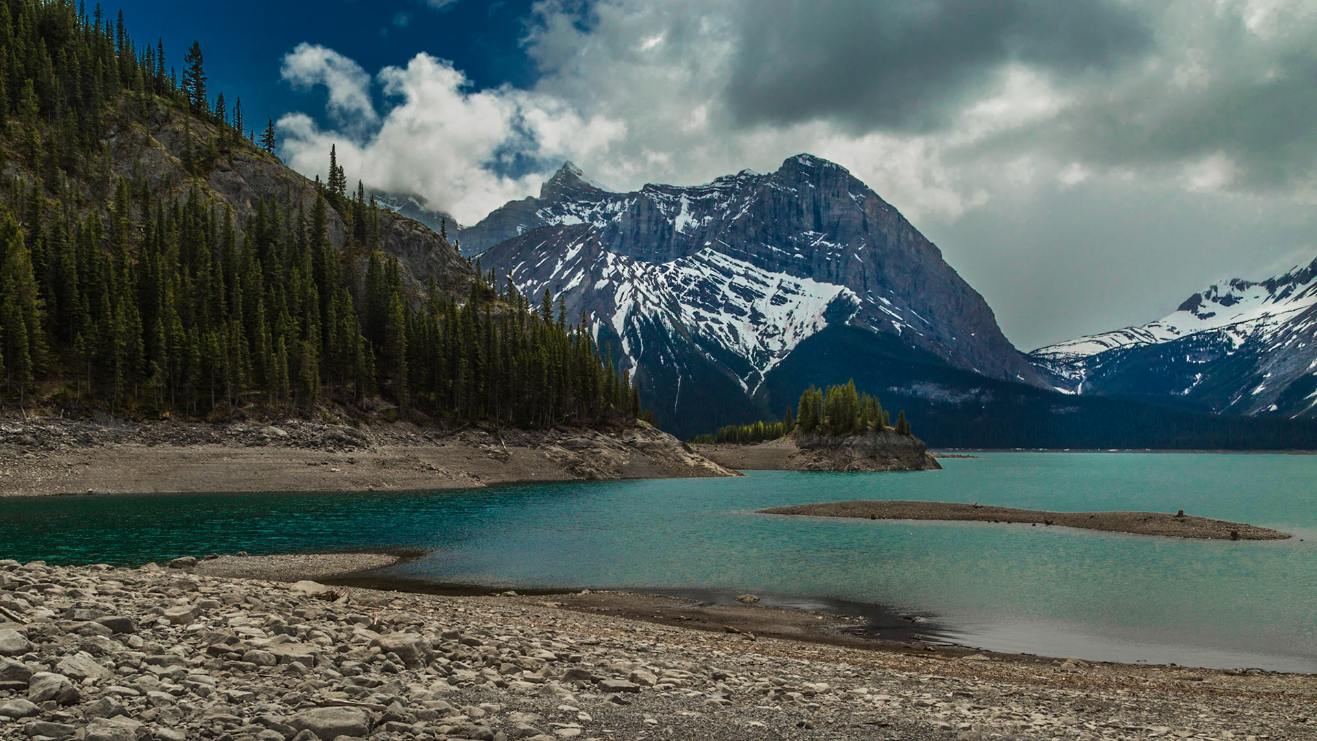 From the peninsula running into the lake, and closer to the surface, the image is very different. Of course, the sky changed considerably also.  I am glad the couple of claps of thunder as we were getting out of the car were the last we heard. If that had continued, we would not have made it to this view.