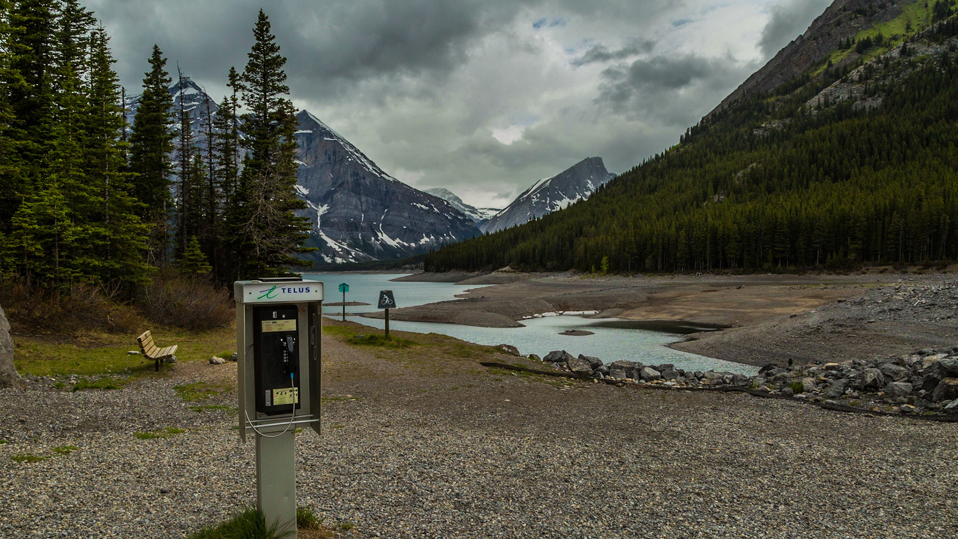 So, when was the last time you saw a pay phone? This one stood out here in the mountains, far from any buildings. The damn was here, which apparently had electric power, to operate the gates. Otherwise this was just a beautiful wilderness. There weren’t even any of those Park Service toilets we see so often in U.S. National Parks. And, there was another interesting feature. A pile of Canadian quarters was on top of the phone box. (http://www.songlyrics.com/the-kingston-trio/desert-pete-lyrics/) It appeared to be like the jar of water for priming the pump Mark and I discussed by the Kananaskis River earlier in the day. See http://bit.ly/1nQViS6.