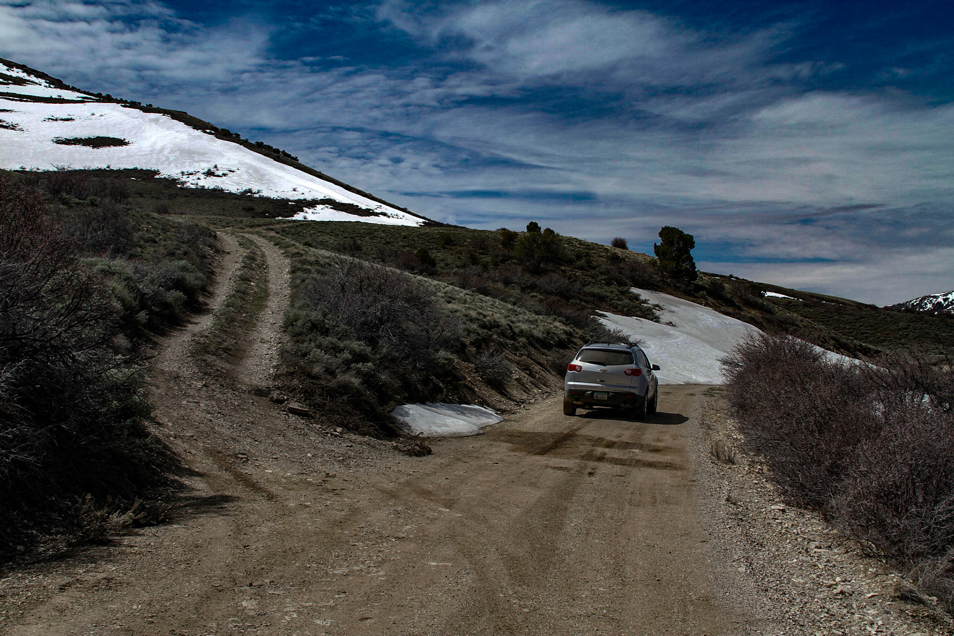 Halmiton Nevada, The First Snow Drift that Stopped Me, May21, 2011 -  A place that had my imagination from early in researching this tirp was Hamilton.  When I found the road, it was a good dirt route and remained so for a good while.  Rounding a bend, I realized I was near the snow line on another mountain across the valley. After a few pictures from there, I moved on.  Then, I rounded a bend to find a snow drift higher than the car across the road.  Walking back to get a shot of the car and the drift, I noticed a rougher road that seemed as though it may by-pass the drift. I tried it, but soon came to a long muddy portion that I decided I should not try.  Then, I saw a traveled trail back to the main road passed the big drift, but before a drift I probably could have navigated.  I decided not to try it, because climbing back up to where I was may have been problematic.  Later I realized there were probably more drifts before Hamilton.  Later in the day I proved it.