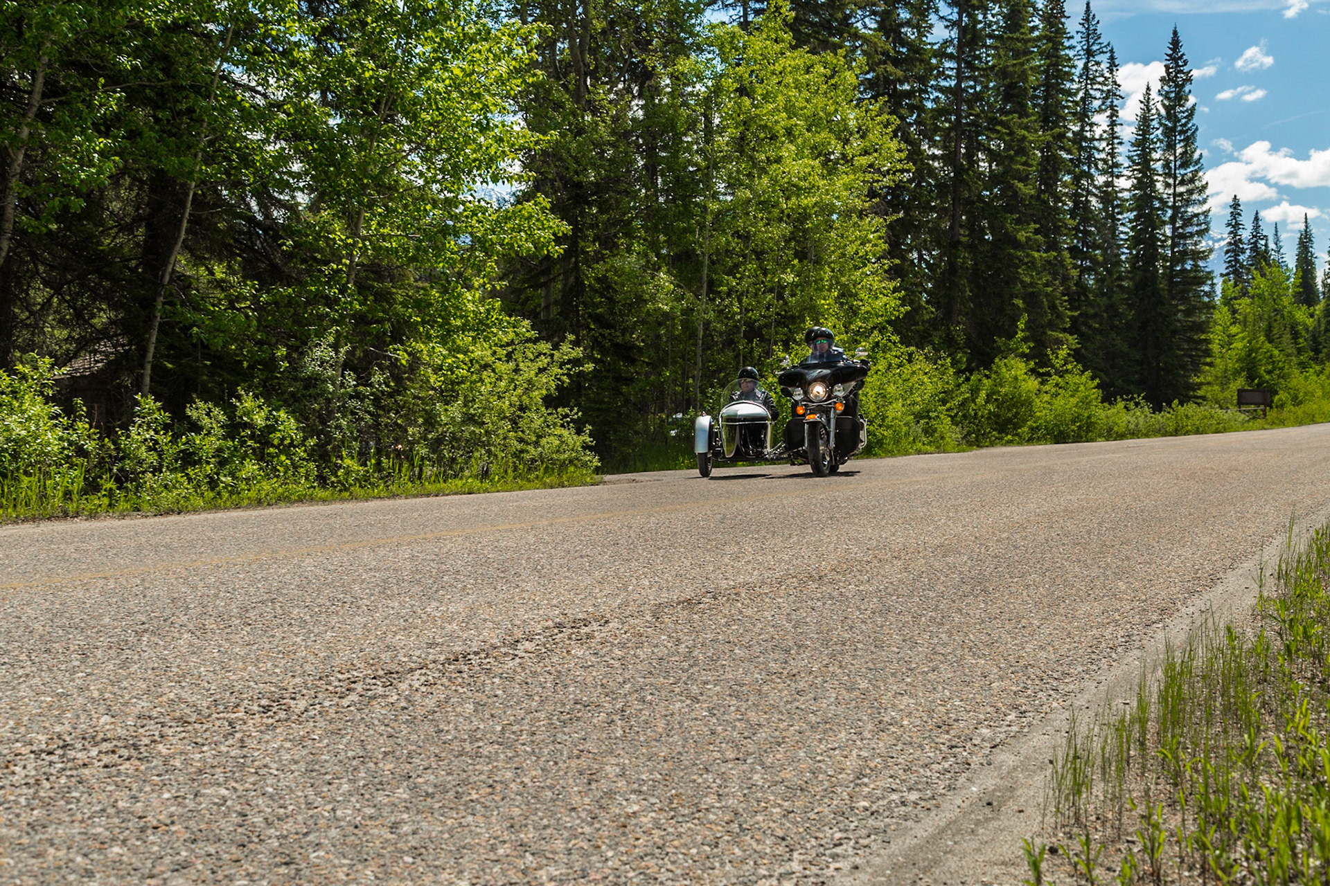 After a day that was mostly getting the flat tire replaced, a pub lunch and our hurried trip north on Icefield Parkway (June 17), we were ready to head south on the route that inspired Jasper, Alberta for this Father’s Day adventure. Highway 93 runs from Jasper to the Mexican border, through a vast array of landscapes. This year, we made it from Jasper to Kalispell. In 2015, we currently expect another lag of the trip. At the rate we travel, it may take three to four years to see all of Highway 93, if we actually make it. Until this point, the 2014 trip was an interesting way to reach our starting point.  The reasons have to do with airline schedules and my interest in seeing this route to Jasper.We began southbound on Icefield Parkway, with time for stops. Soon, we took a turn for a closer view of the Athabasca River, where we met five or six motorcycles with sidecars. Our reaction was wishing for a chance to shoot pictures. When this road turned away from the river we returned to a picnic area on the river. The motorcycles were there. It turns out they were not some kind of club, as we imagined. They were a Jasper tourist attraction. Guys in their 40s or 50s drove, carrying two tourists each – aging couples in this case. They were resting, before their return to Jasper on the road that might have been the “old highway” into Jasper.  We talked long enough to get a sense for their “mission.” That ride was probably expensive. When they were climbing into and onto the machines, we headed to setup for their departure. We got our chance for the shots we wanted earlier.