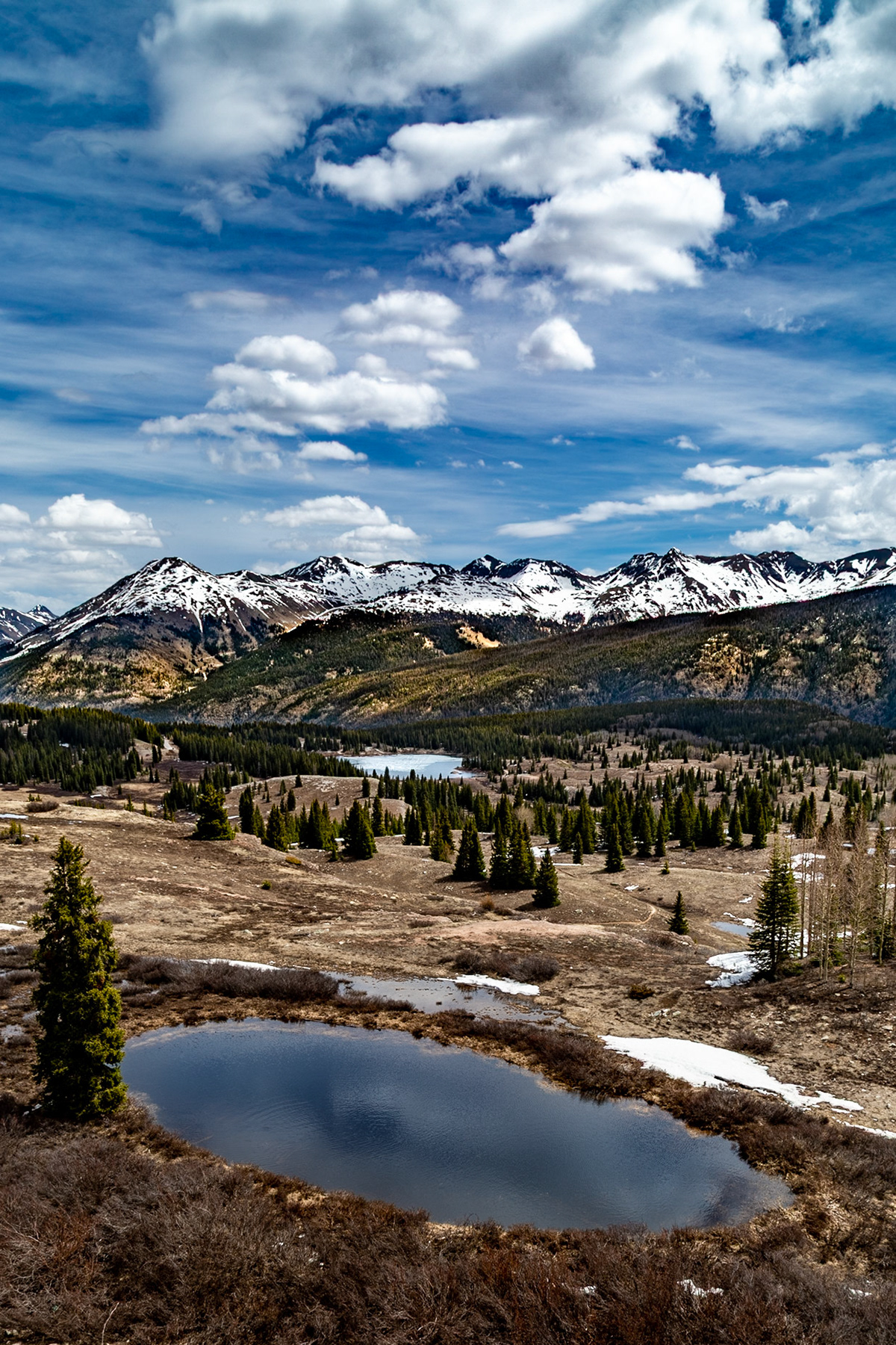 Molas Pass along San Juan Skyway, Altitude 10,238 ft. with Foreground Water and Big Molas Lake Still Frozen