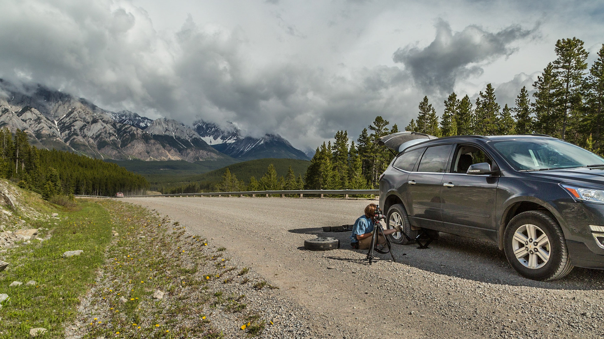 Every adventure needs a mishap. We were gone from home 8 days, carrying a lot of photographic equipment and other stuff. To my knowledge, this tire was the only thing we lost. When it happened, I was in denial until we got stopped and Mark said “No, it is flat.” The torn place was at least an inch long. Otherwise, I was in luck, with a thirty year old guy thrilled to set up a GoPro camera to record the entire operation. It’s not joke. He had the tripod set up in just the right place, before we started figuring out how to get the temporary tire and jack out of the curious storage places. His camera rigging took about the same amount of thought as getting ready to jack the car. Then I was able to enjoy the wilderness beauty while he became the star of his movie.