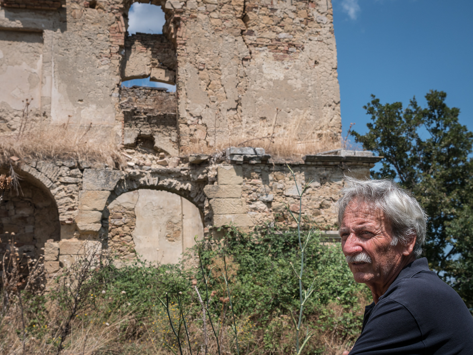 Here I'm using the very harsh light of midday to create a visual parallel between this man's wrinkles and the cracks in the building behind him