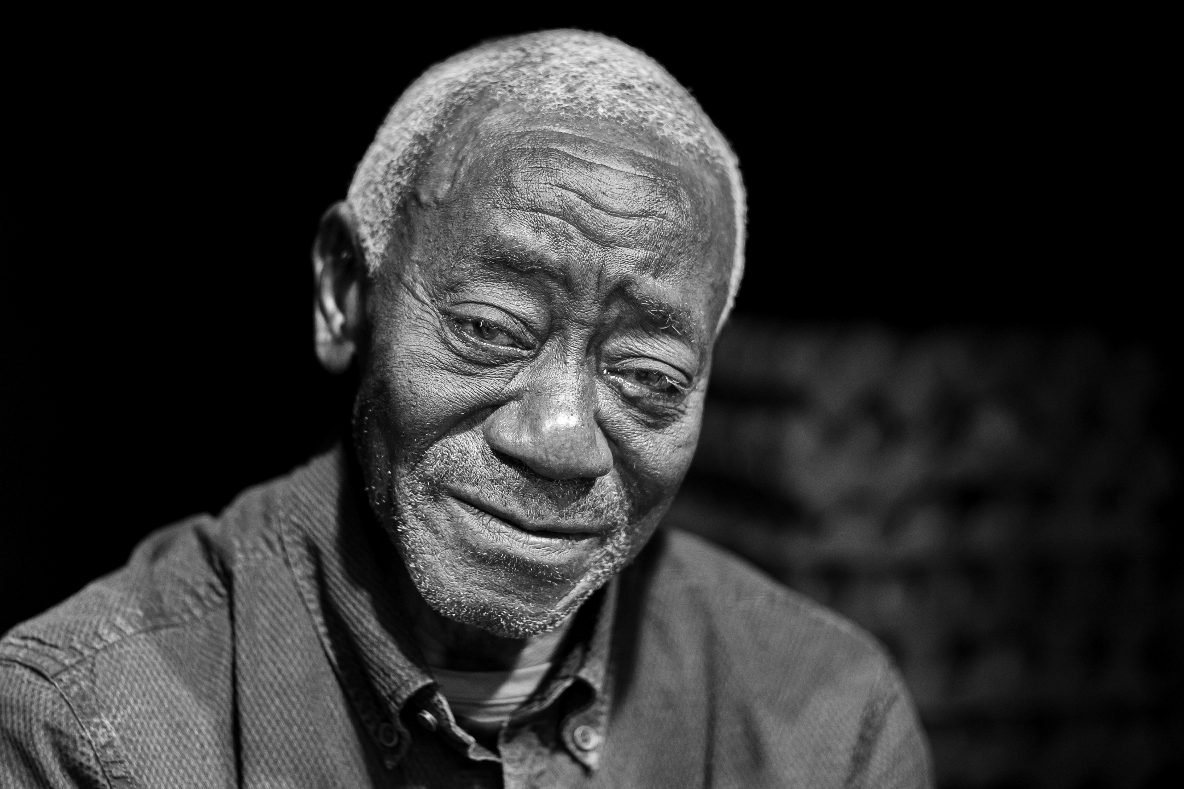 Black and white street portrait at Art Basel, radiating a deeply fragile, vulnerable, and intimate atmosphere. Candid photography by Carmine Castelli