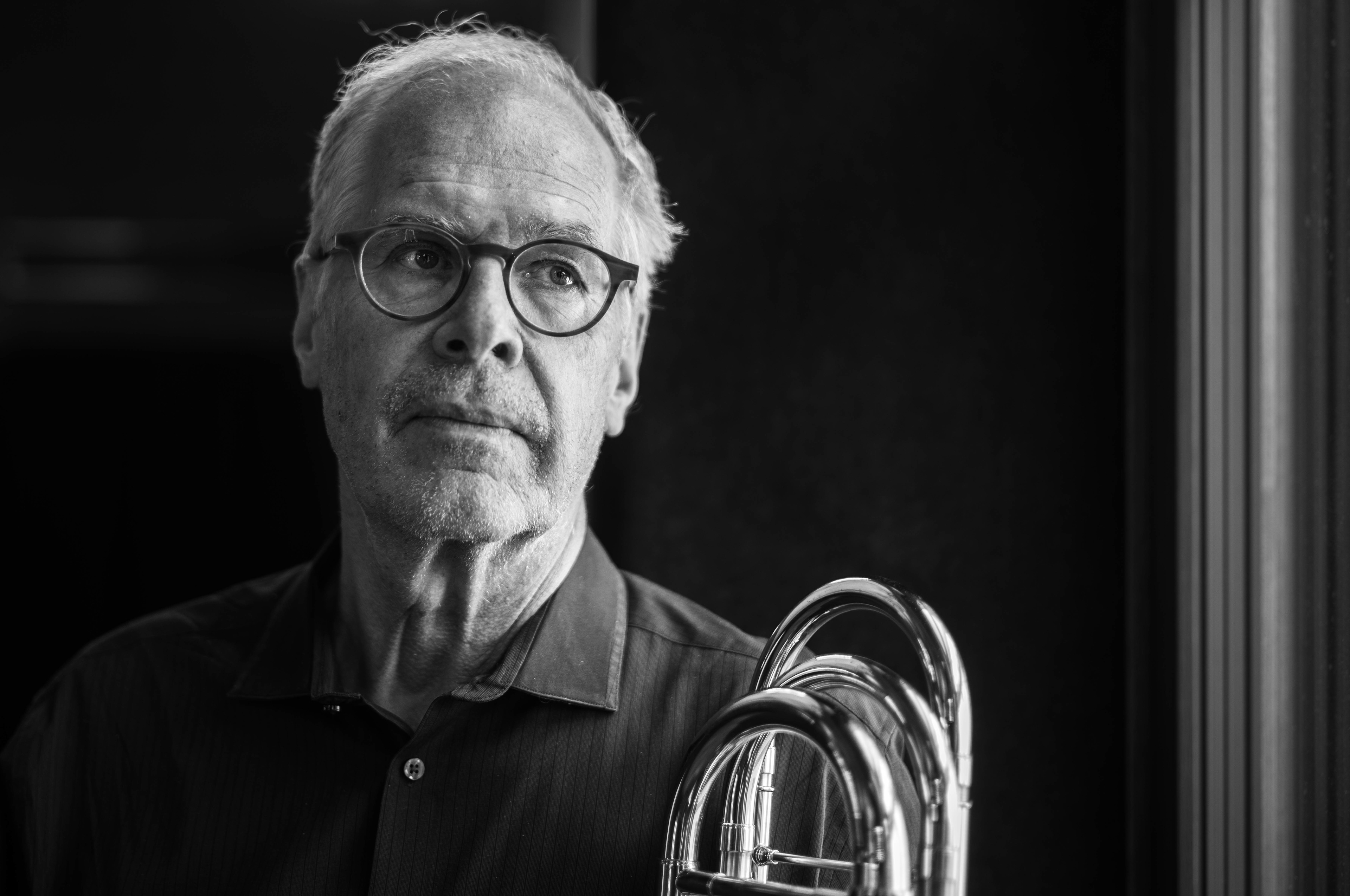 Portrait of Prof. Dr. Thierry Carrel with his trombone at SMOMS at Stadtcasino Basel, driven by a deep desire to help others. 