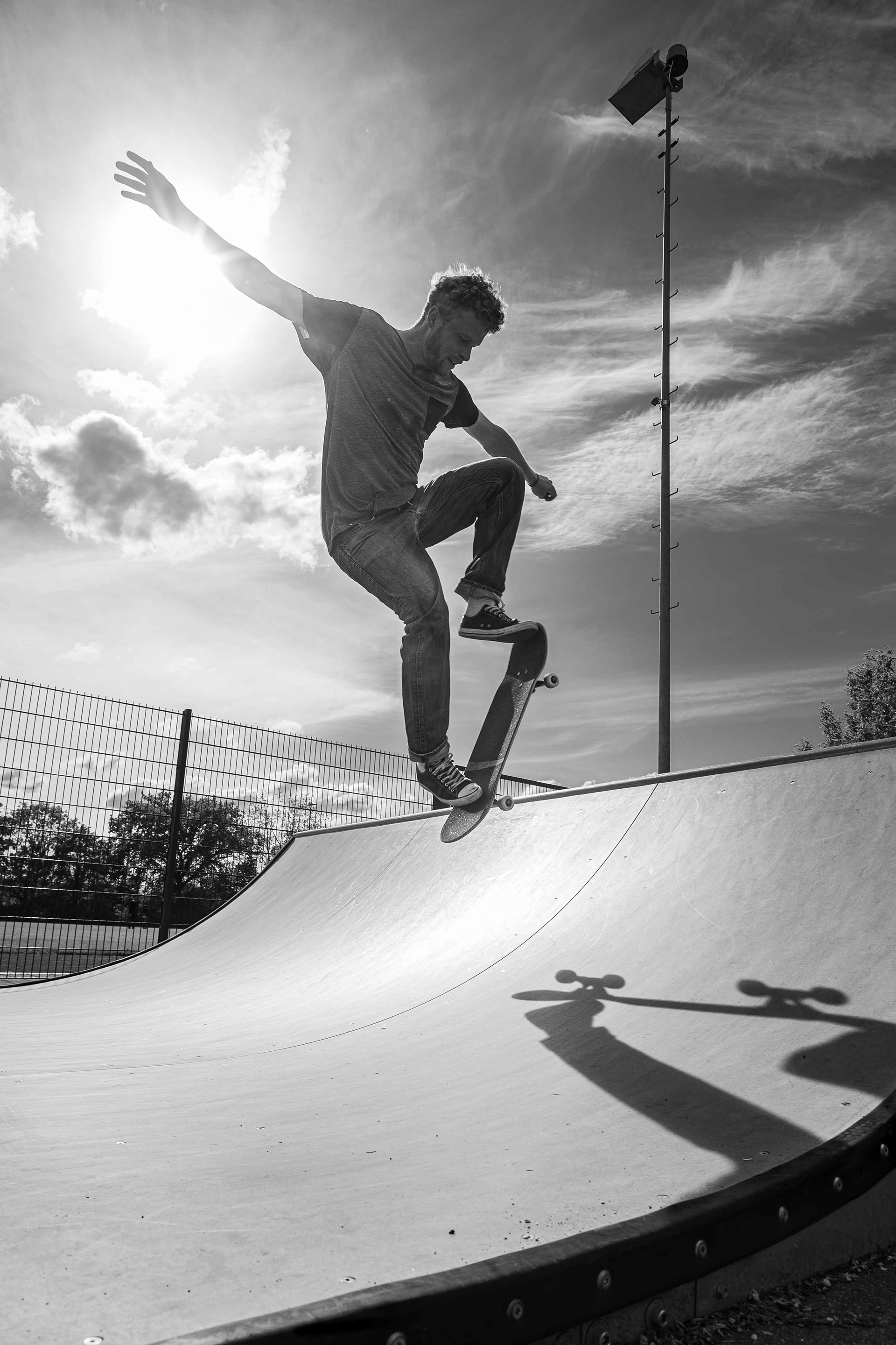 Golden Silhouette with skateboarder Dave, floating dynamically in mid-air with his skateboard for a fraction of a second. Photography by Carmine Castelli