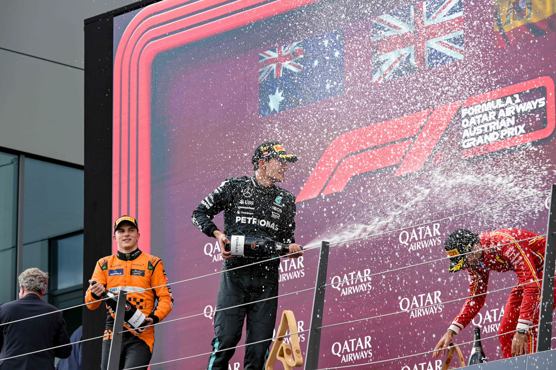 George Russell #63, Mercedes-AMG Petronas F1 Team und Carlos Sainz #55, Scuderia Ferrari und Oscar Piastri #81, McLaren Formula 1 Team auf dem Podium.;Formel 1 GP Austria / Österreich. Sonntag, 30.06.2024