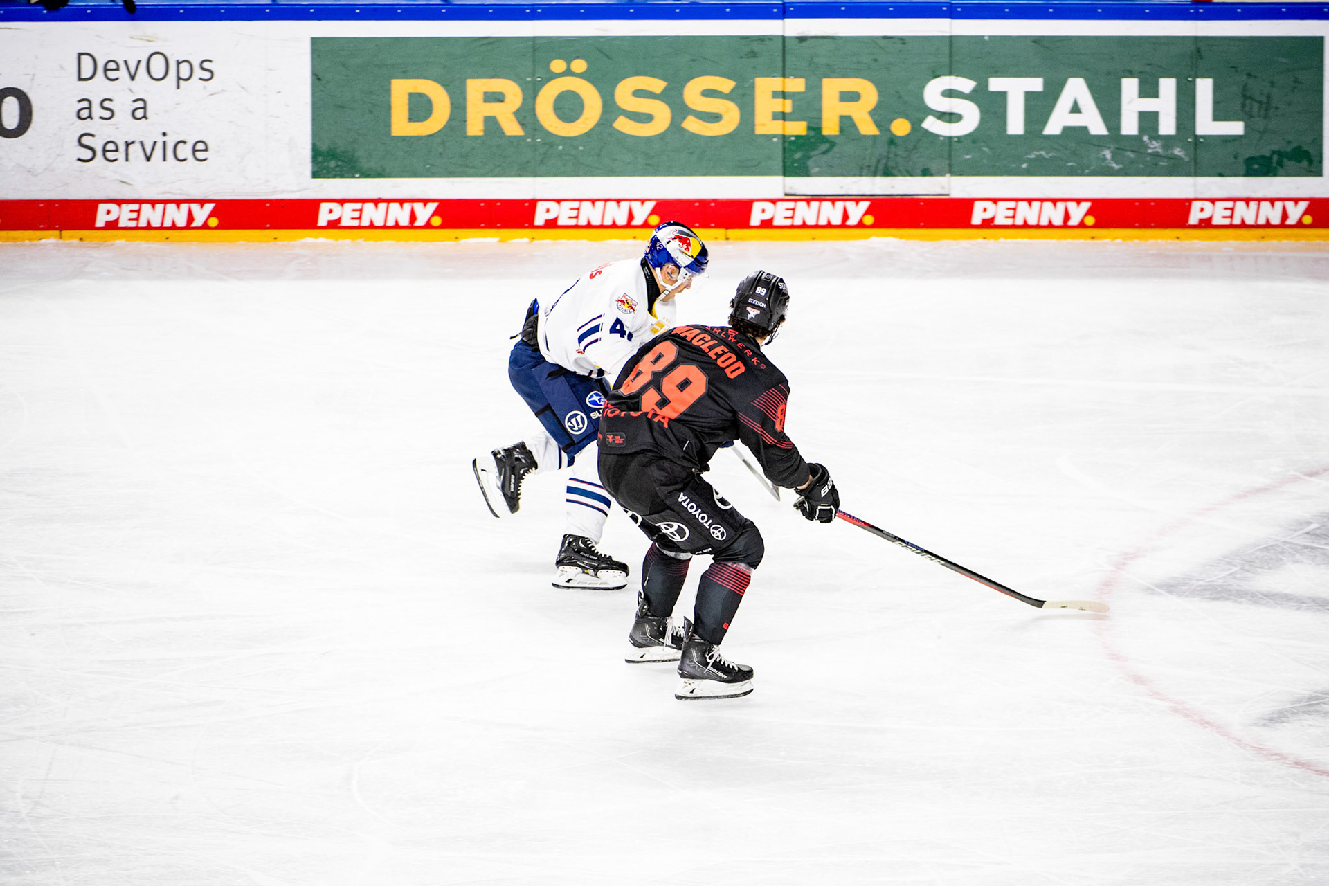 Gregor Macleod im Zweikampf mit Andrew MacWilliam; DEL Kölner Haie - EHC Red Bull München, 05.01.2024