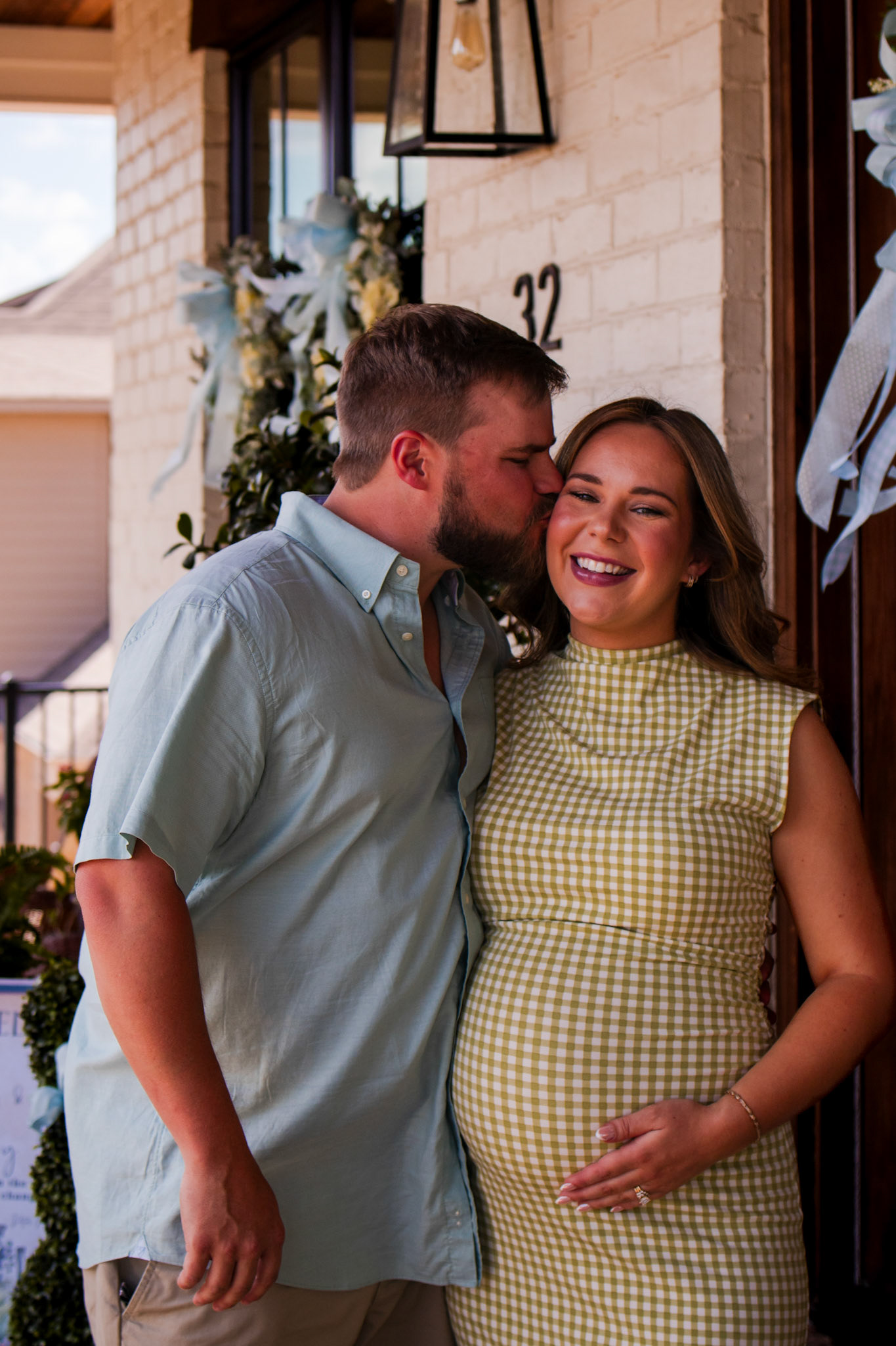 Intimate event photographer in Arkansas capturing a candid, joyful moment of a mother-to-be at her baby shower.