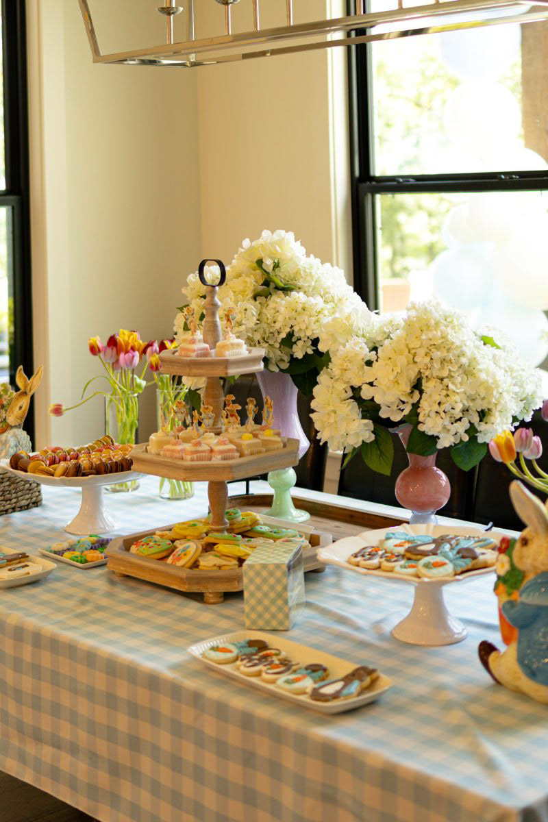	A beautifully curated dessert display with elegant treats and floral arrangements at a Little Rock, Arkansas baby shower. Detail photography for wedding events and catering.