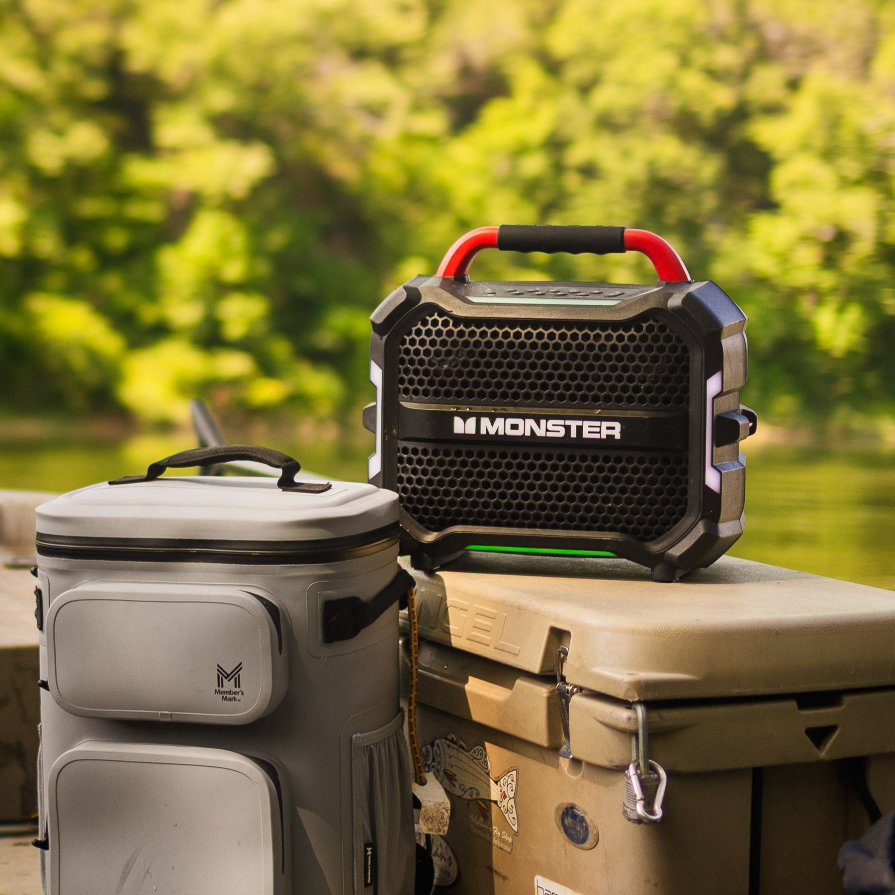 Outdoor lifestyle product imagery of Monster speaker on a boat deck next to a cooler on Sam's Club website.
