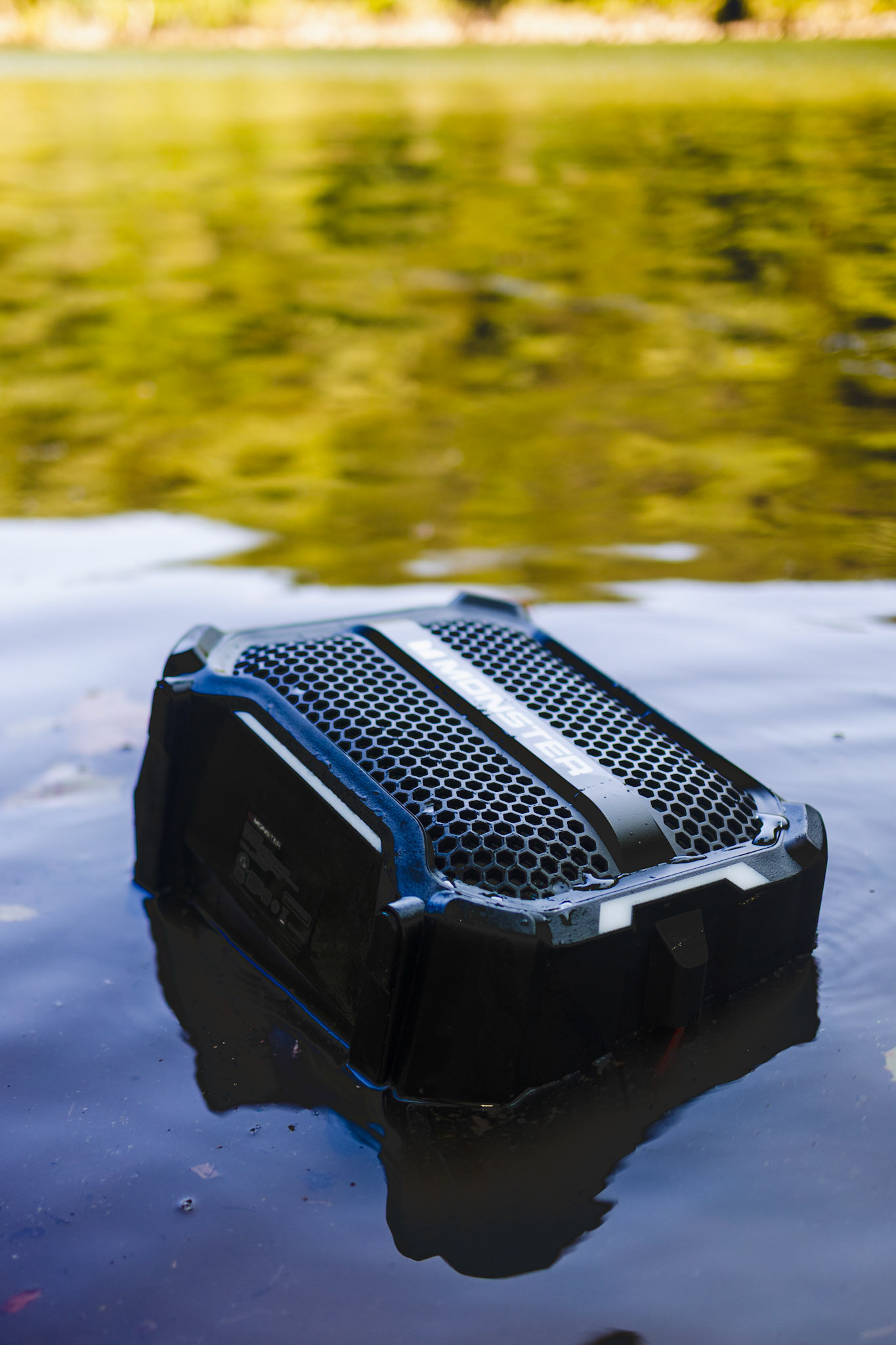 Golden hour sunlight reflecting on rippling water, capturing the atmospheric brand story of the outdoors.