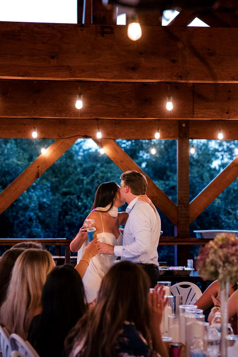 	The happy couple sharing a sweet embrace during their rehearsal dinner celebration in Sevierville, TN . Candid wedding photographer capturing pre-wedding events.
