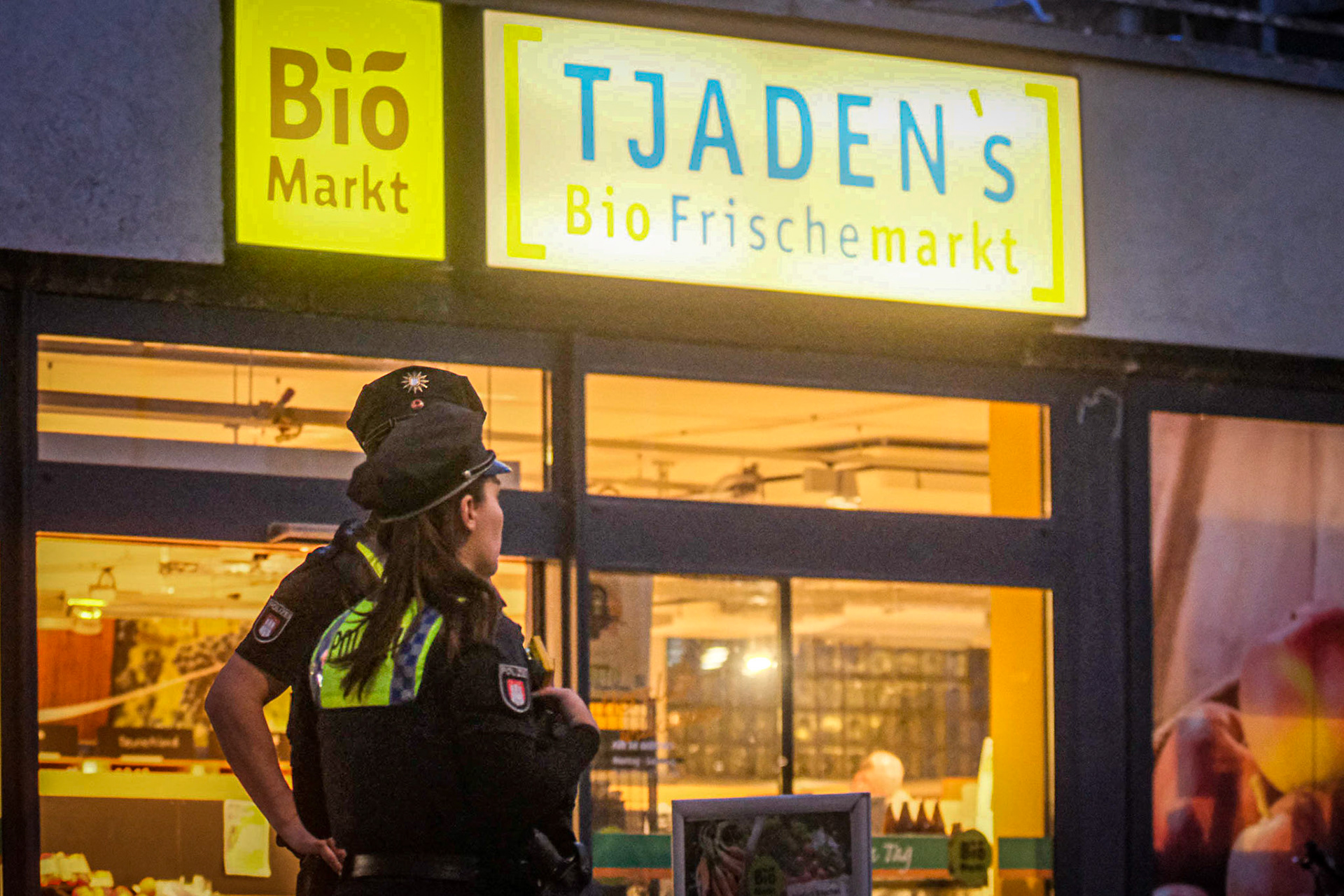 Wieder ist eine Filiale der Hamburger Bio-Supermarktkette Tjaden's überfallen worden: Ein unbekannter Täter soll den Laden an der Martinistraße in Eppendorf am Freitagabend gegen 19.30 Uhr mit einer Pistole betreten und damit einen Mitarbeitenden bedroht haben. Der Täter sei anschließend mit einem noch unbekannten Geldbetrag geflüchtet. Die Polizei war mit einem Großaufgebot im Einsatz. Auch ein Hubschrauber kam zwischenzeitlich zum Einsatz und kreiste über den Norden Hamburgs. Kleidungsstücke, die vom Täter stammen könnten, wurden in Tatortnähe sichergestellt. Verletzt wurde nach ersten Erkenntnissen der Polizei niemand. Um kurz vor Mitternacht wurde die Fahndung nach dem Täter zunächst eingestellt. Der Kriminaldauerdienst die Ermittlungen übernommen. In den vergangenen Wochen und Monaten hatten unbekannte Täter insgesamt fünfmal eine andere Filiale des Biomarkts an der Fruchtallee in Eimsbüttel überfallen. Die Polizei geht von einem Wiederholungstäter aus.