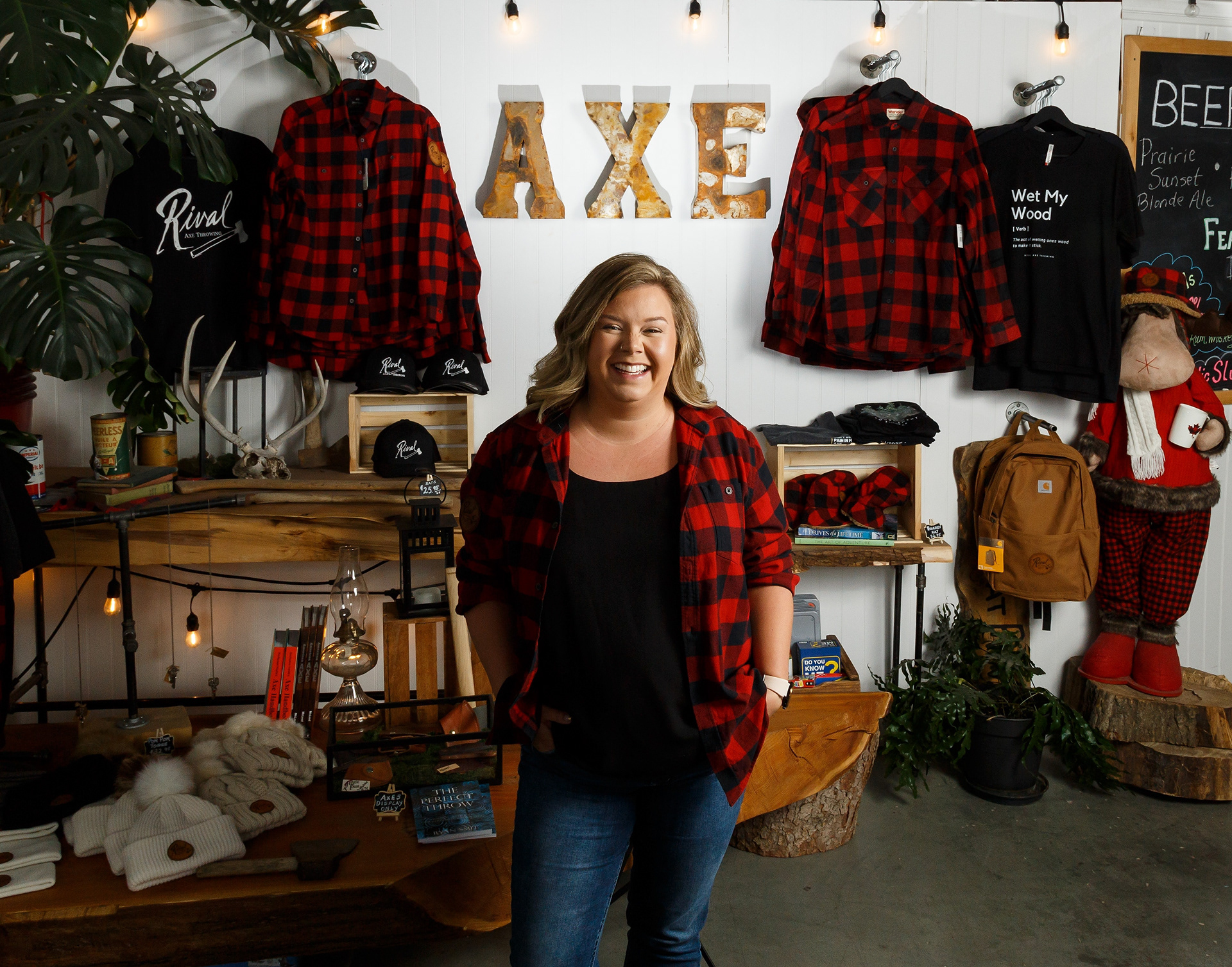 Jena Storms poses for a portrait at Rival Axe Throwing in Airdrie on Friday, March 18, 2022. Storms owns and operates Rival Axe with her mother, Joni. The business features a gift shop, snack stand and six axe throwing cages.