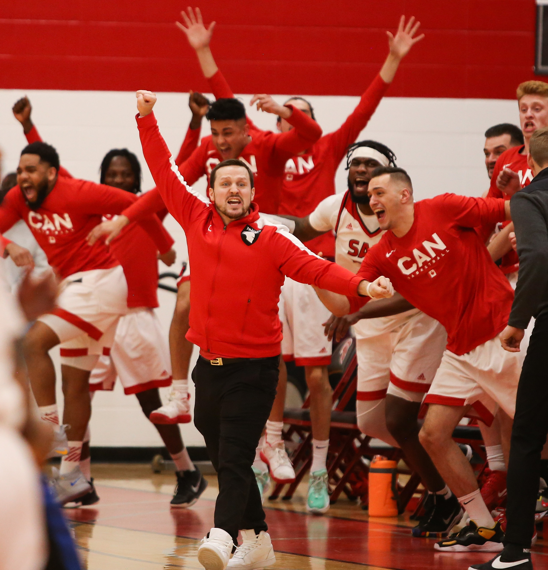As the buzzer rings the SAIT Trojans celebrate their fifth ACAC win at SAIT’s Campus Centre gym in Calgary on Saturday, March 12, 2022. The Trojans defeated the Keyano Huskies 91- 88 during the Alberta Colleges Athletic Conference gold medal championship game. This is the fifth year in a row where the Trojans have won gold in the ACAC.