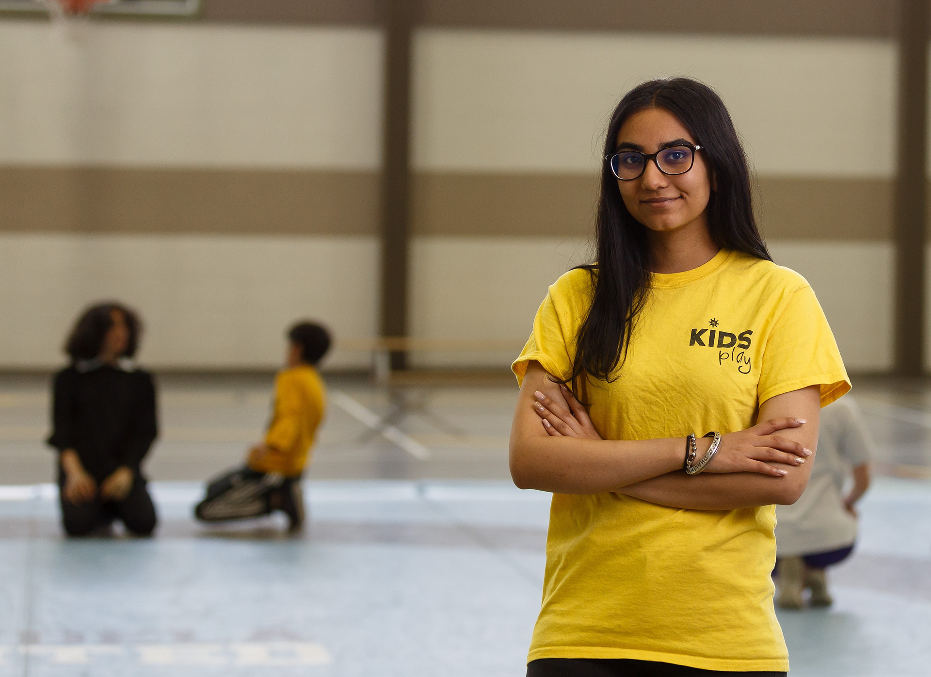 Arleen Dhaliwal poses for a photo in the Feature Gym in the Genesis Centre in Calgary on Tuesday, June 28, 2022. Dhaliwal has volunteered with the Kids Play Foundation for the past year. Every Tuesday night they meet at the Genesis Centre to teach junior and senior high kids wrestling. The foundation exits to help keep kids away from drugs, violence, and gangs through free programs. (Photo by Anna Burns/SAIT)