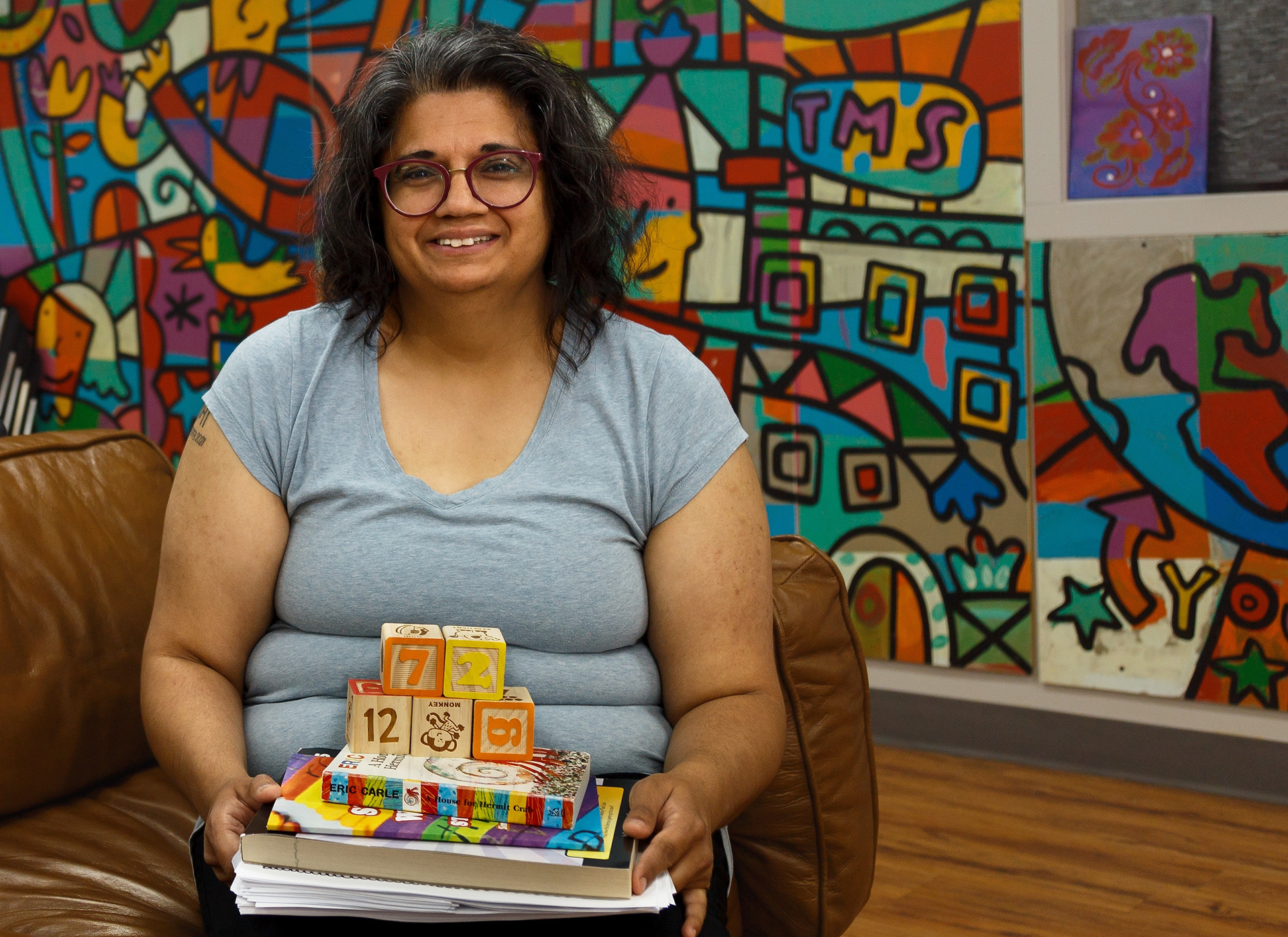 Nina Decaire poses for a photo in the Mustard Seed’s Neighbour Centre in Marlborough Park in Calgary on Friday, June 17, 2022. Decaire has volunteered with the Mustard Seed for over three years and often runs reading programs for young children.