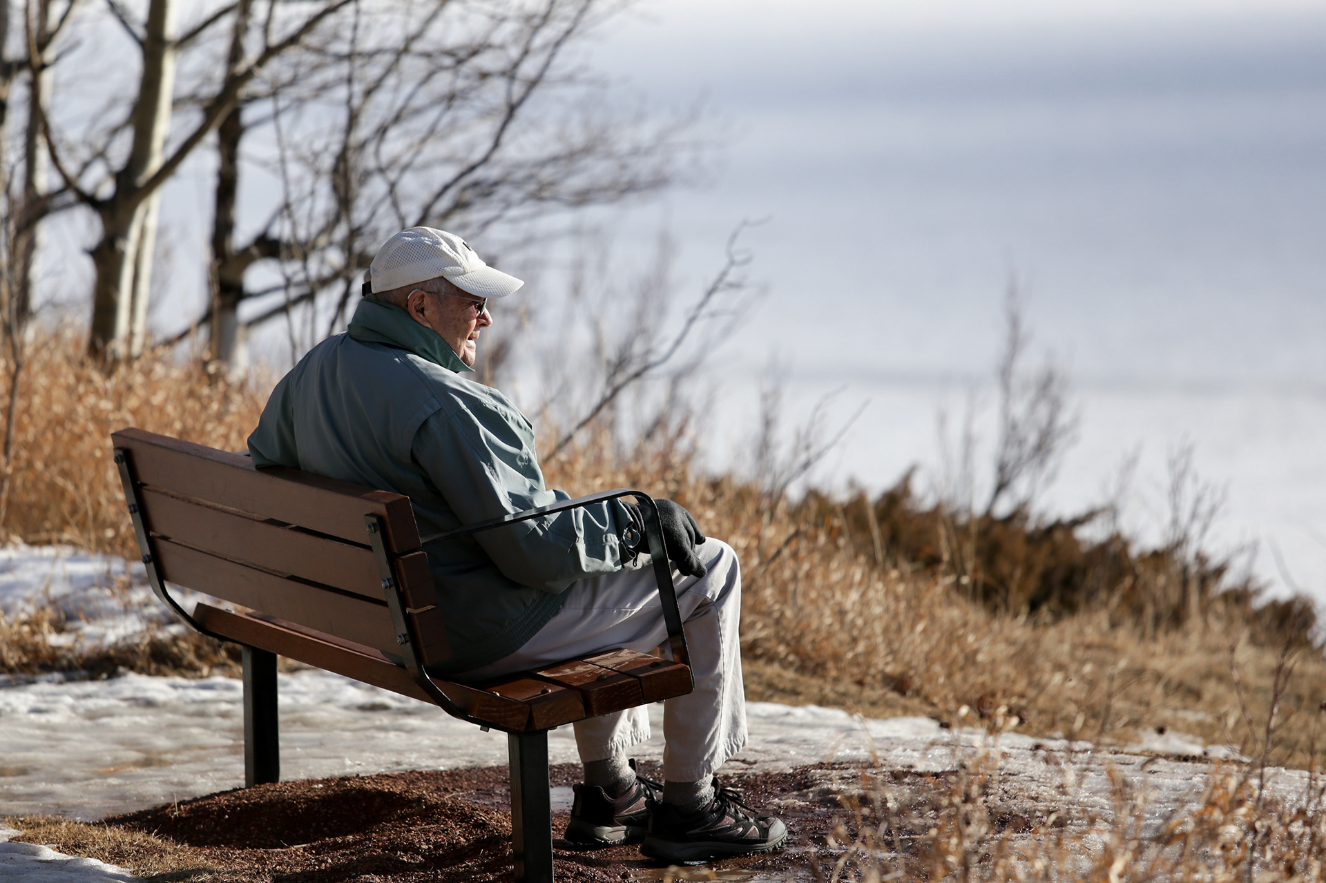 An older gentleman sits at a bench in North Glenmore Park in Calgary on Sunday, Jan. 23, 2022.