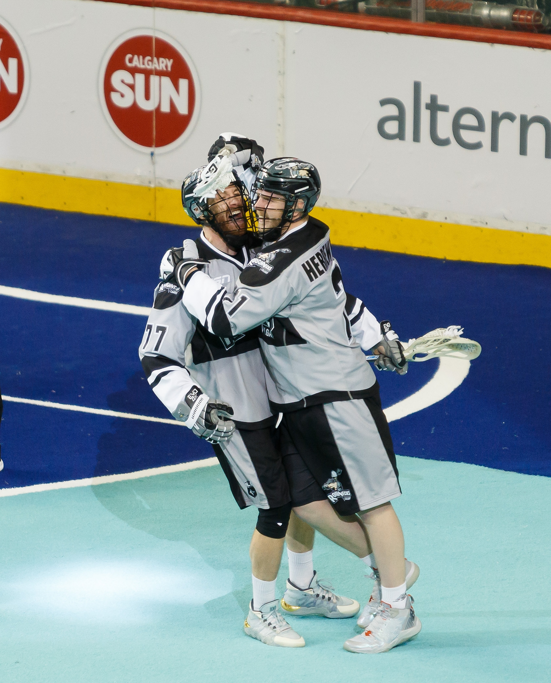 Zach Herreweyers and Zach Currier of the Roughnecks celebrate a goal on Panther City at the WestJet Field in Scotiabank Saddledome in Calgary on Saturday, April 9, 2022. The Roughnecks defeated Panther City 14- 4 during the National Lacrosse League regular season play. Tonight the Roughnecks tied a franchise record for fewest goals against in a single game.