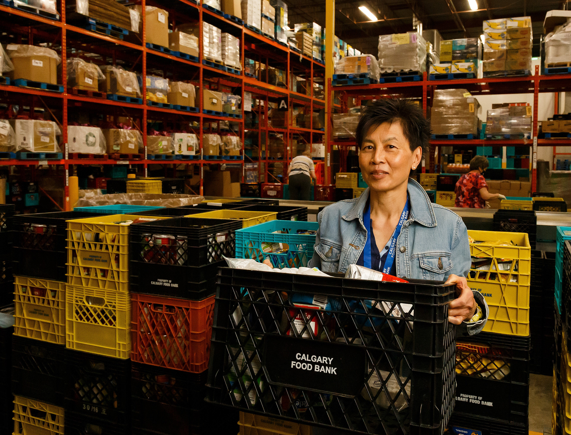 Brenda Quon poses for a photo in the Calgary Food Bank distribution centre in Calgary on Friday, May 27, 2022. Quon has volunteered at the food bank since 2012. She started in the distribution centre and now volunteers in the call centre.