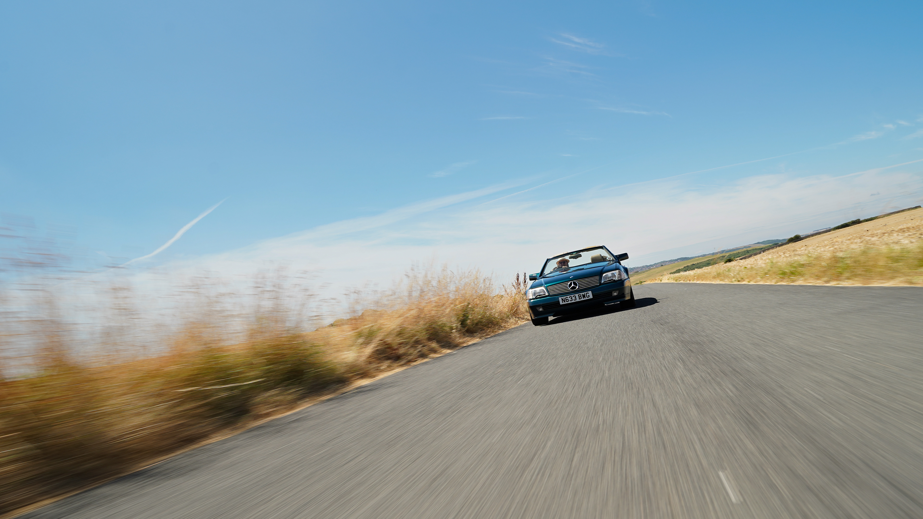 Mercedes SL320 driving in Seaford, roof down.