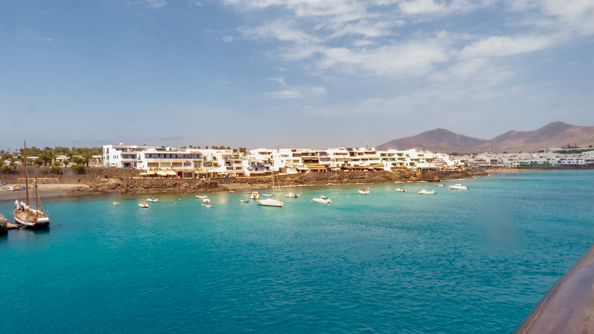 Playa Blanca Lanzarote A view of boats in the harbour and the main town and seafront