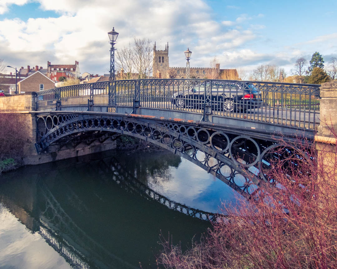 Newport Pagnell.  The Historic Tickford Iron Bridge with the Church of St Peter and St Paul  in the background,.
