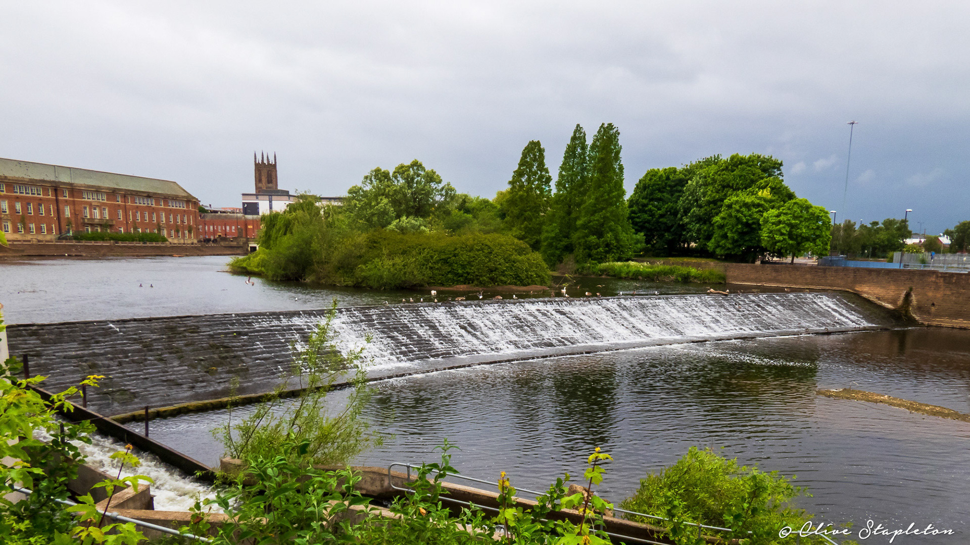 The river Derwent in Derby City Center showing weir, Council House and Cathedral