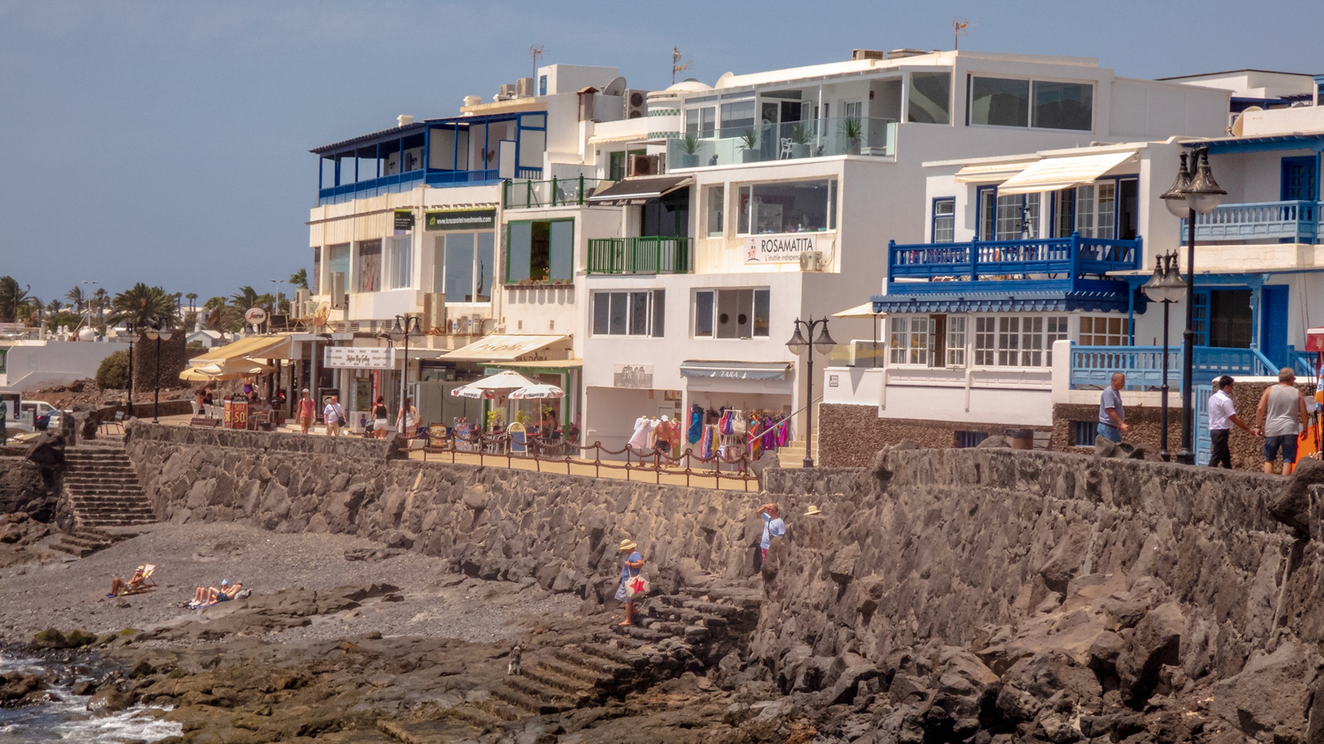 Playa Blanca Lanzarote, The promage with shops and resturants and showing a small beach