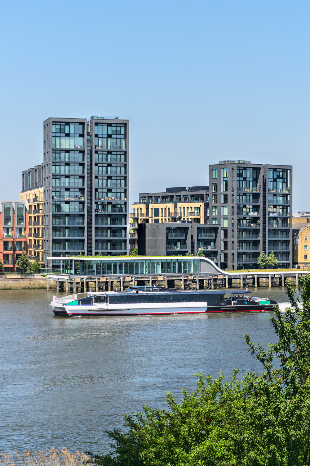 A Taxi Boat on Thames River in London passing by Fulham Riverside Development