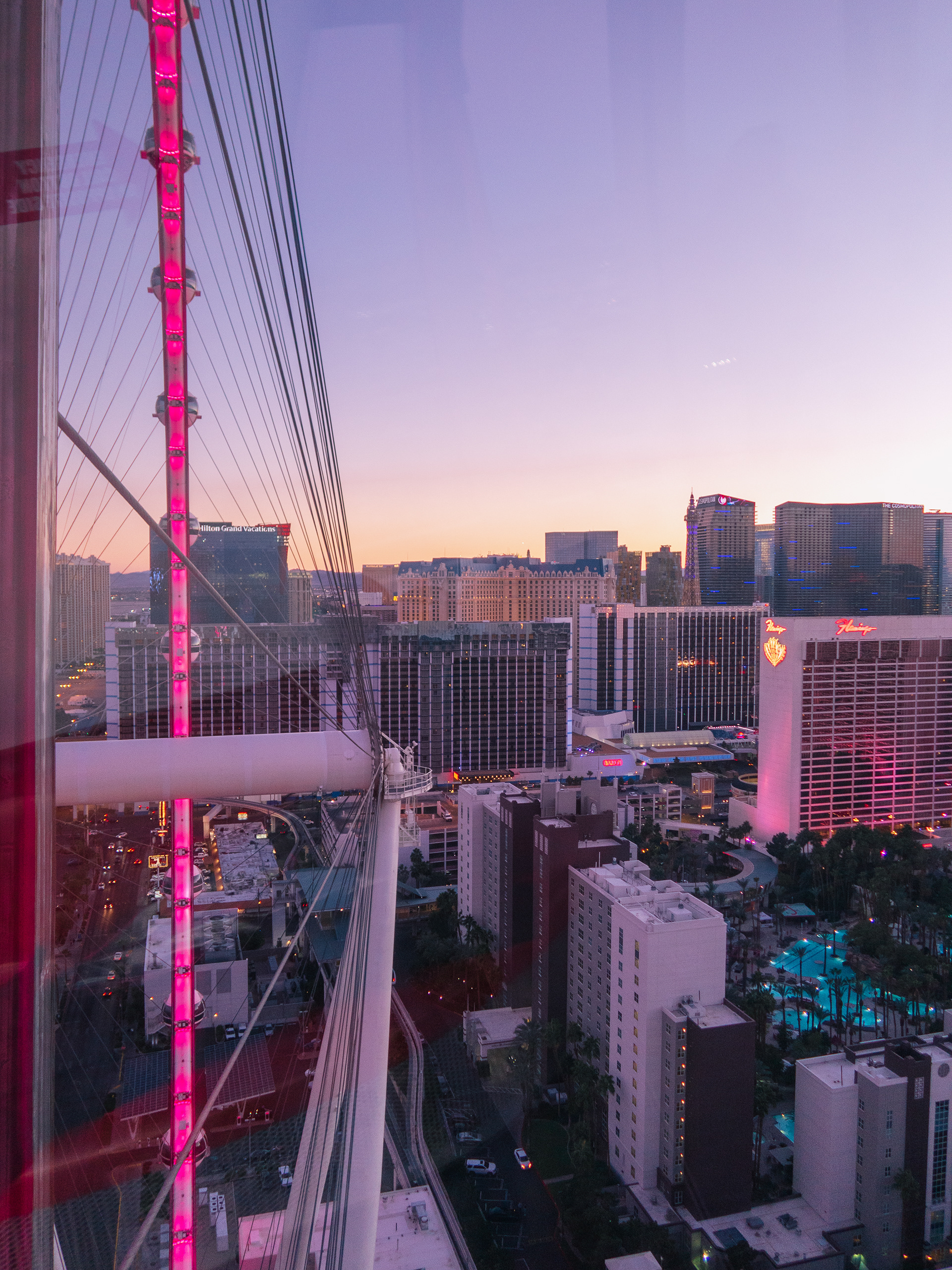 January 2022 - Las Vegas city skyline viewed from the High Roller at dusk with hotels in view, pink lights, and a clear, sunset sky. Photo: Savannah Lee Rowley
