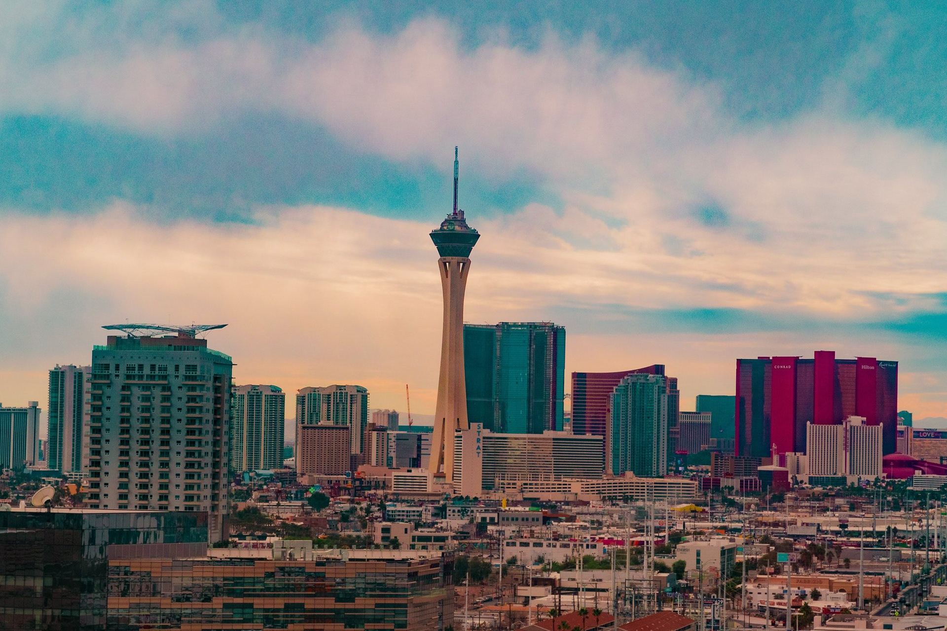 January 2022 - The Las Vegas strip view from the Plaza Hotel with cloudy blue skies featuring The Strat Hotel in Las Vegas, Nevada. Photo: Savannah Lee Rowley