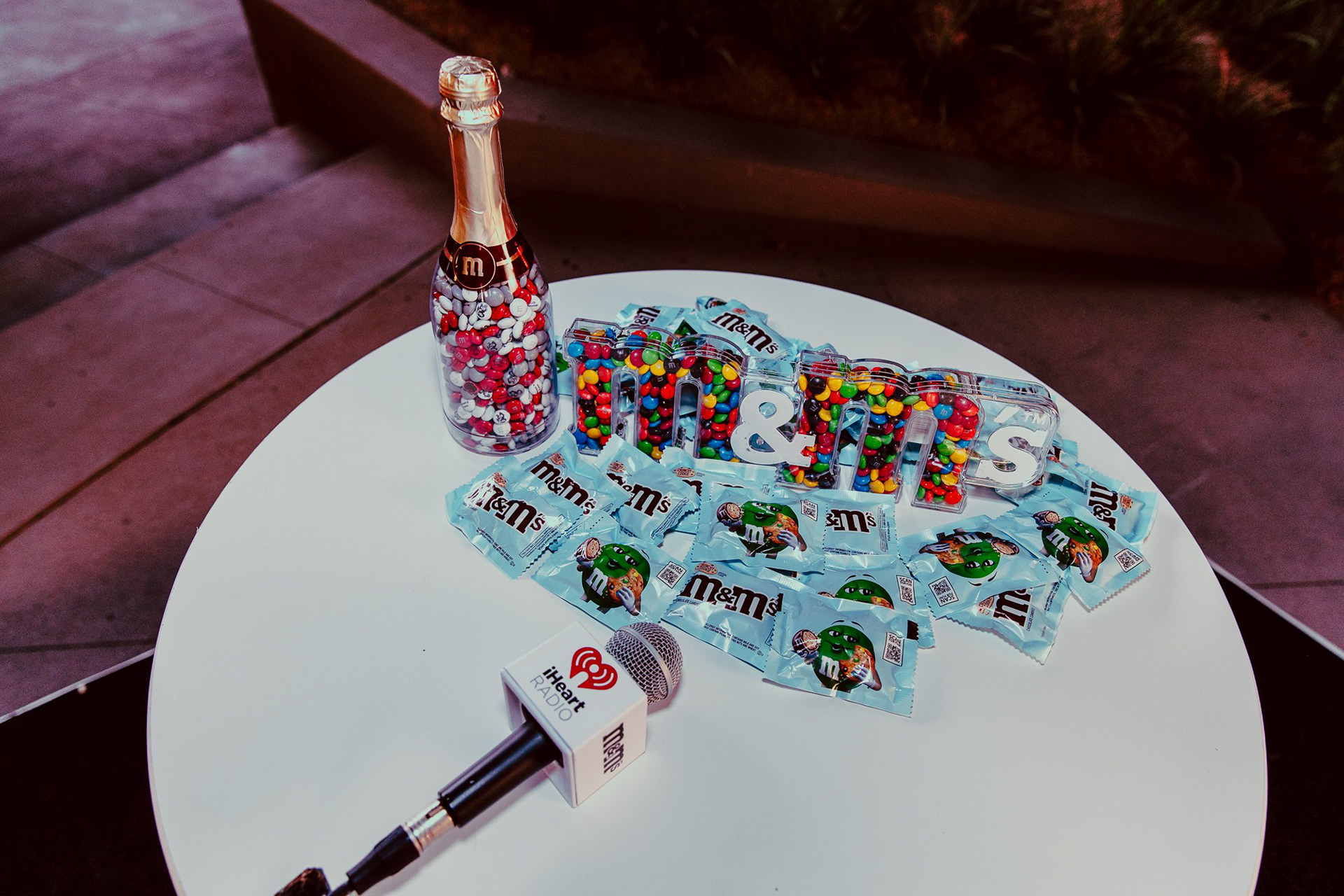 Product presentation of the iHeartRadio and M&Ms collaboration unveiling a new product line enticing fans as they depart the festival..