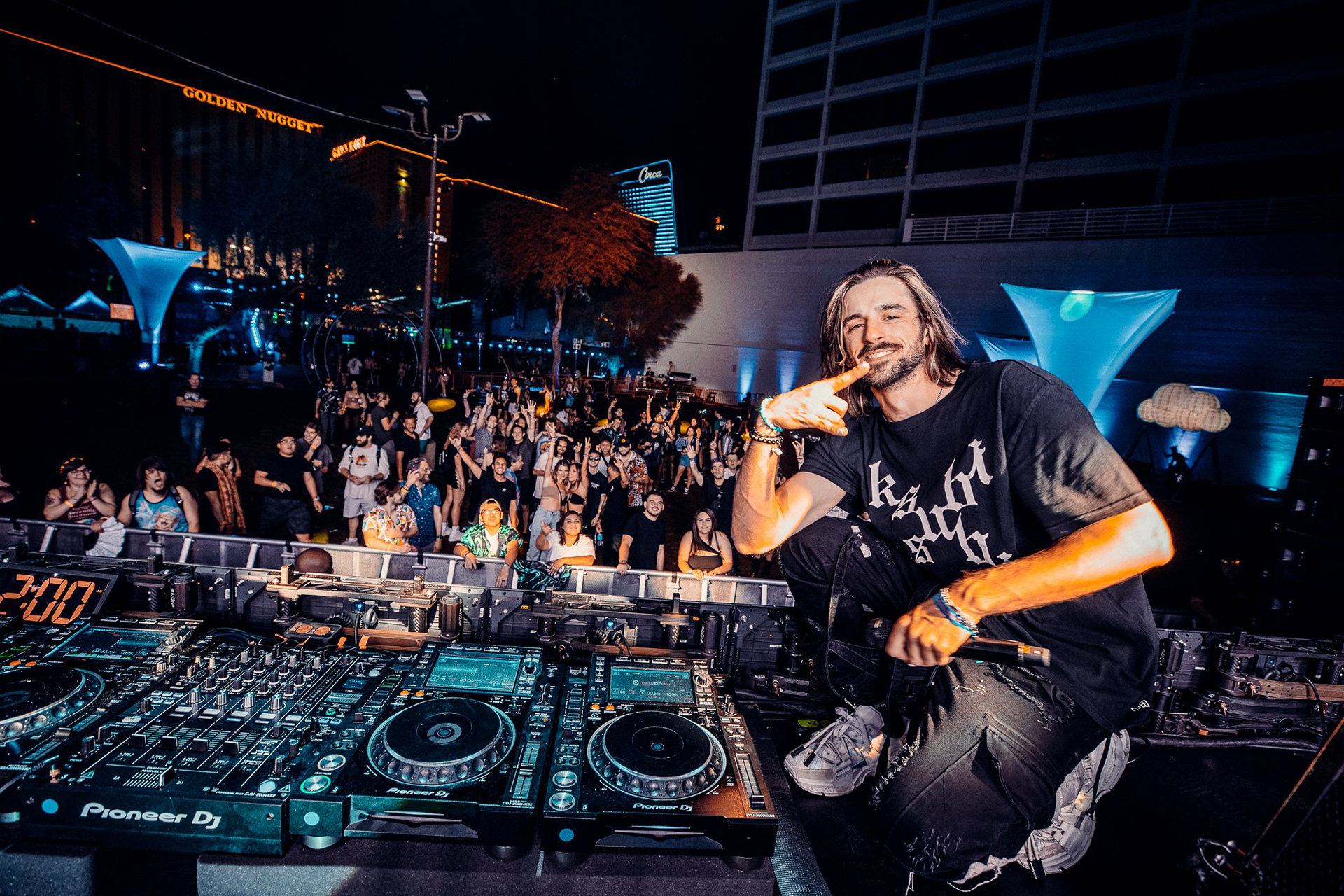 Artist IfFound capturing a moment with the Lost in Dreams festival crowd. This on-stage portrait highlights the energy of the performance set against the iconic Downtown Las Vegas skyline.