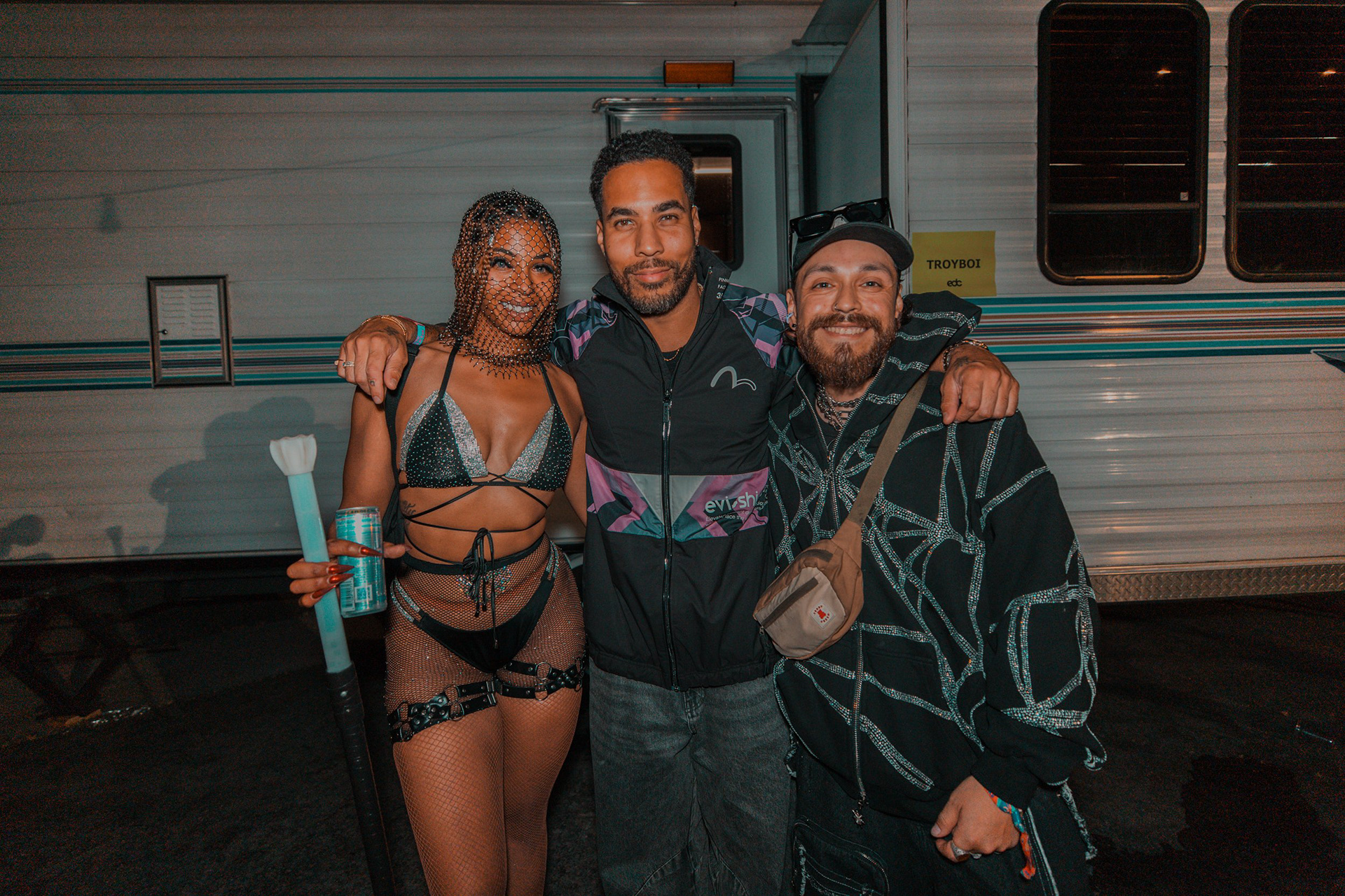 EDC Las Vegas charity winners posing with artist Troyboi. A study in high-stakes event philanthropy at the Las Vegas Motor Speedway.
