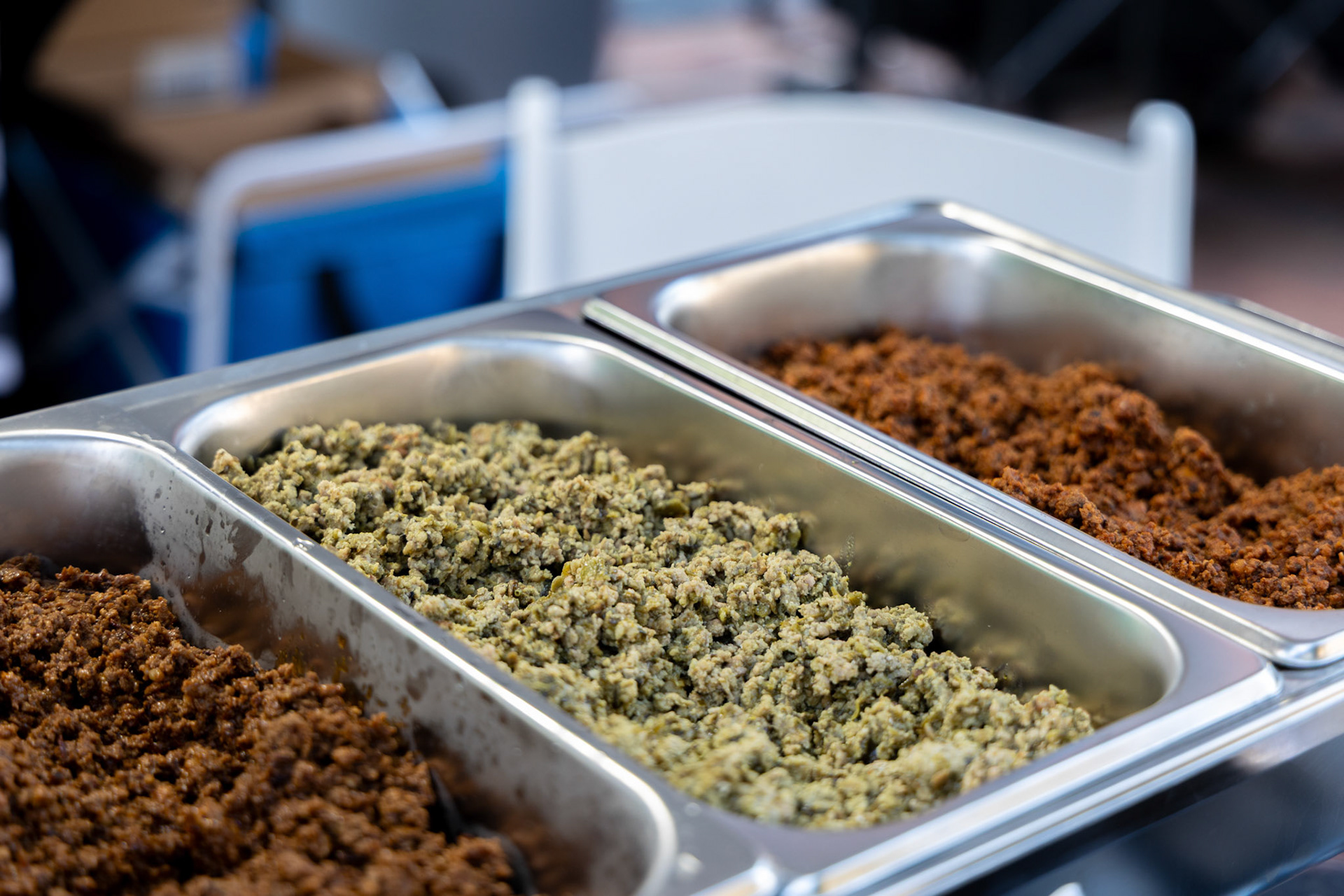 Chorizo made with Abuela’s Original Chorizo Paste sits in a food warmer for sampling  at her booth during the Quest for Texas Best showcase at the Pearl on Sept. 24, 2025.