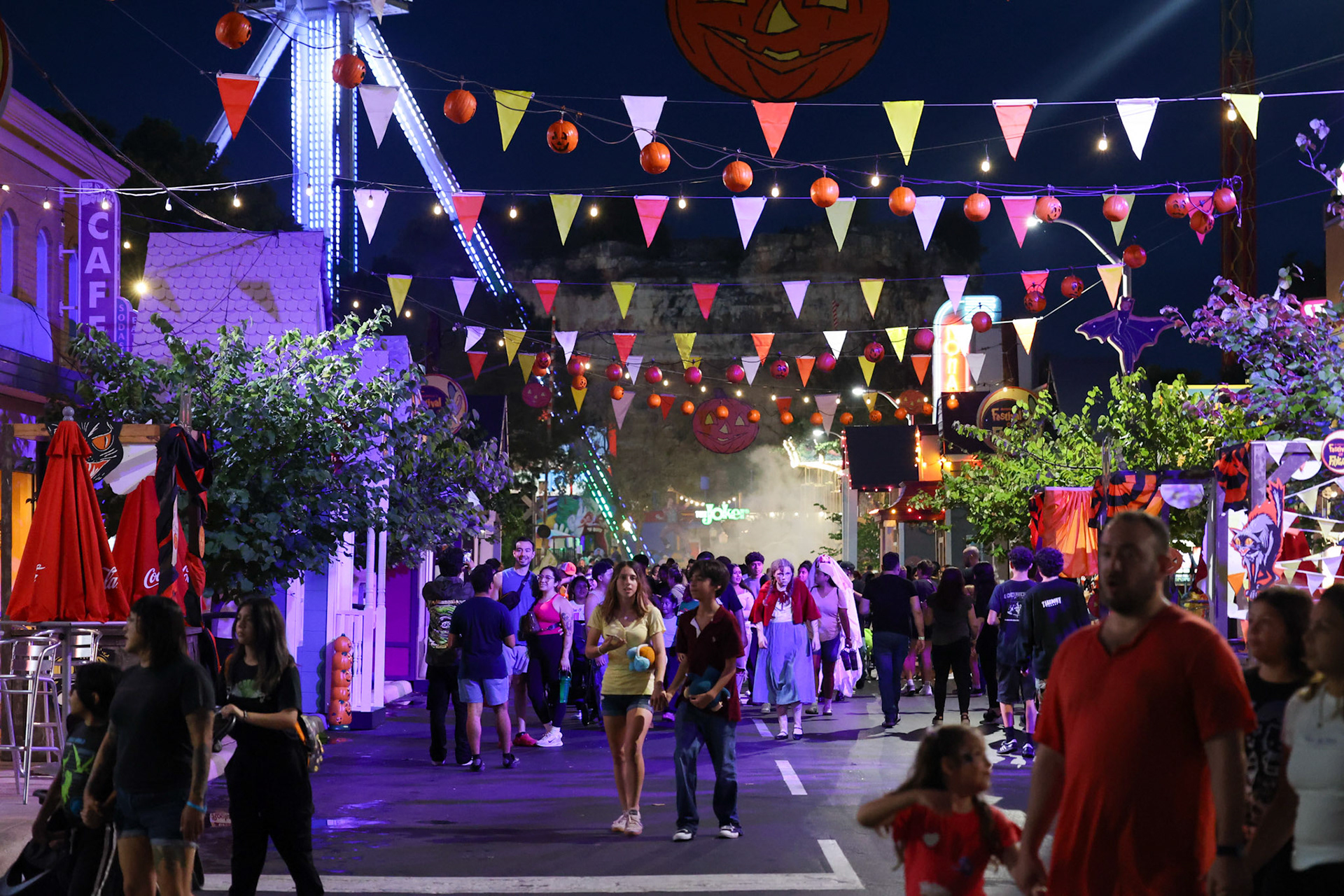 Parkgoers walk through a scare zone on the opening night of Fright Fest at Six Flags Fiesta Texas in San Antonio on Sept. 6, 2025.