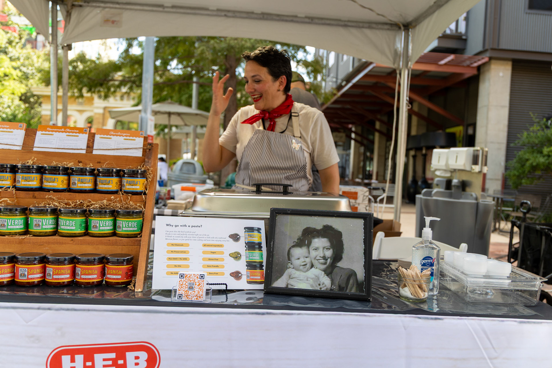 Maria Flores of Hess Street Foods, winner of H-E-B’s 2024 Quest for Texas Best, sets up her booth at the Quest for Texas Best showcase at the Pearl on Sept. 24, 2025.