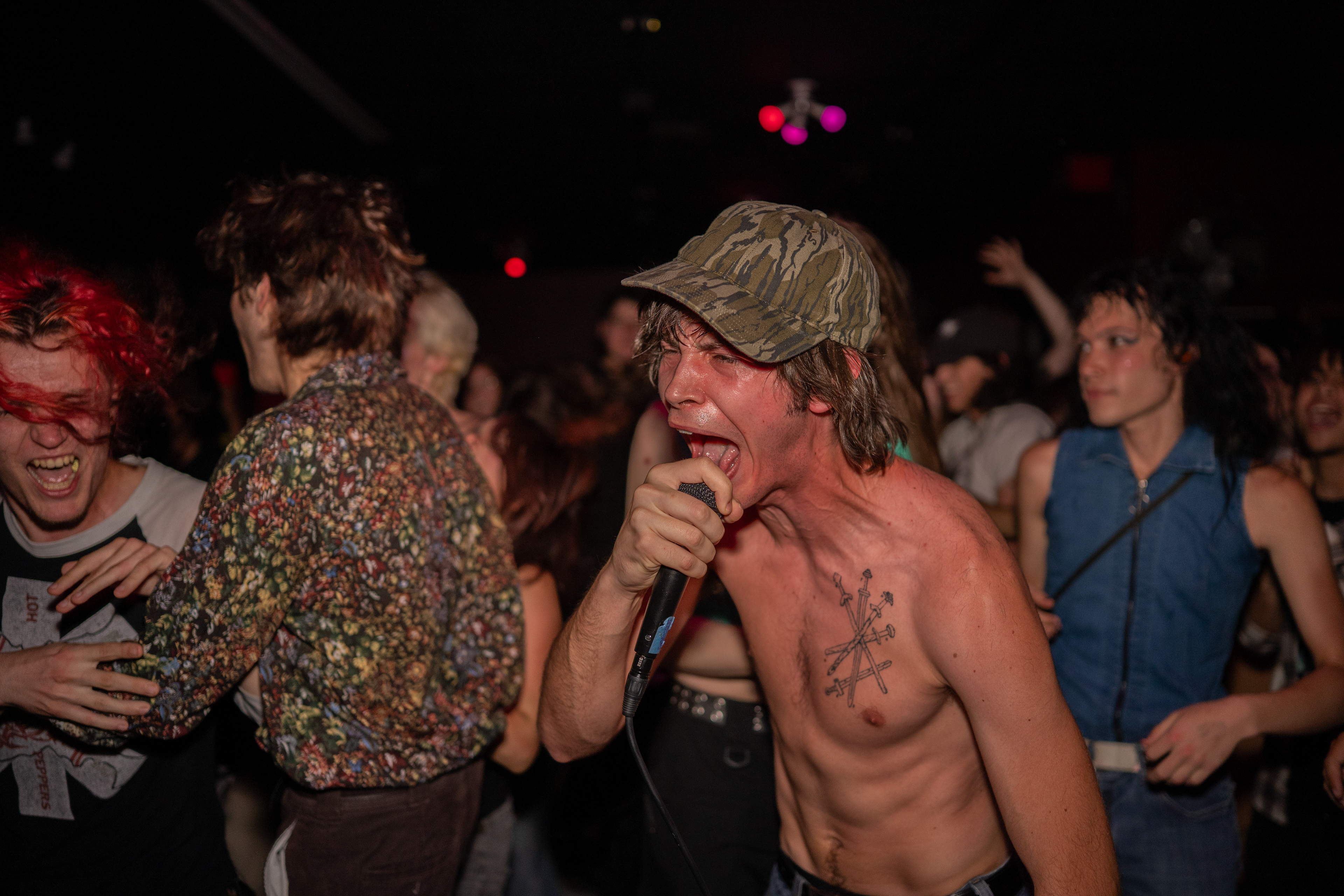 Jackson Magill, lead singer and guitarist for Nexttojackiekennedy, performs in front of a mosh pit during Alchemy Records’ final show on April 26, 2025, in San Marcos, Texas.