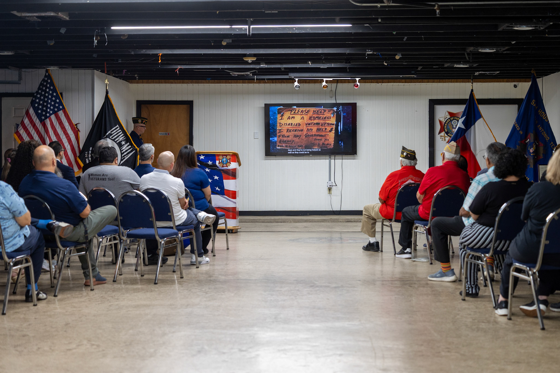 Attendees sit in the meeting room at VFW Post 76 during the third annual Memorial Flag Ceremony honoring Texas Veteran Suicide Prevention Day on Monday.