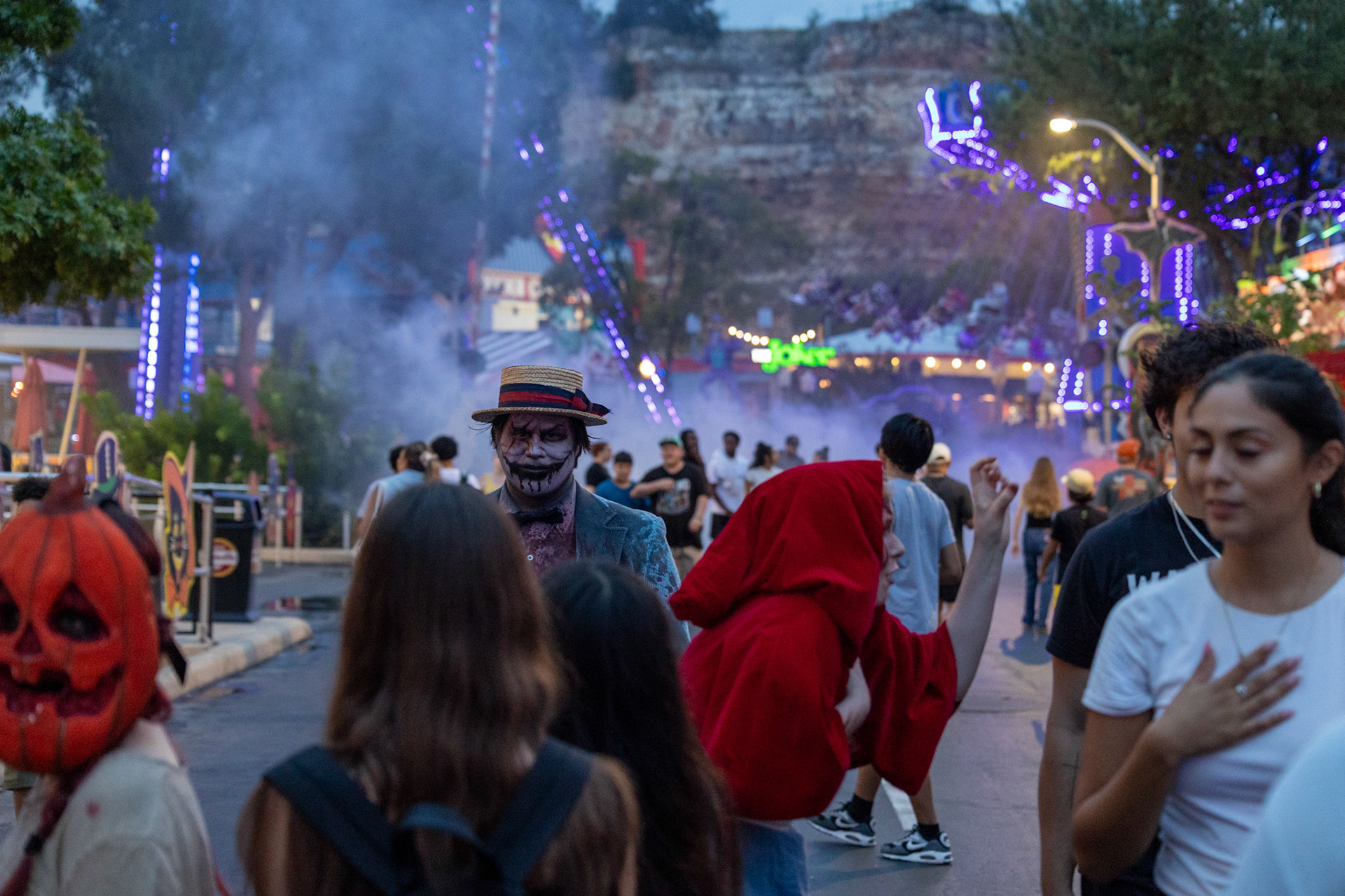 Parkgoers walk through a scare zone on the opening night of Fright Fest at Six Flags Fiesta Texas in San Antonio on Sept. 6, 2025.