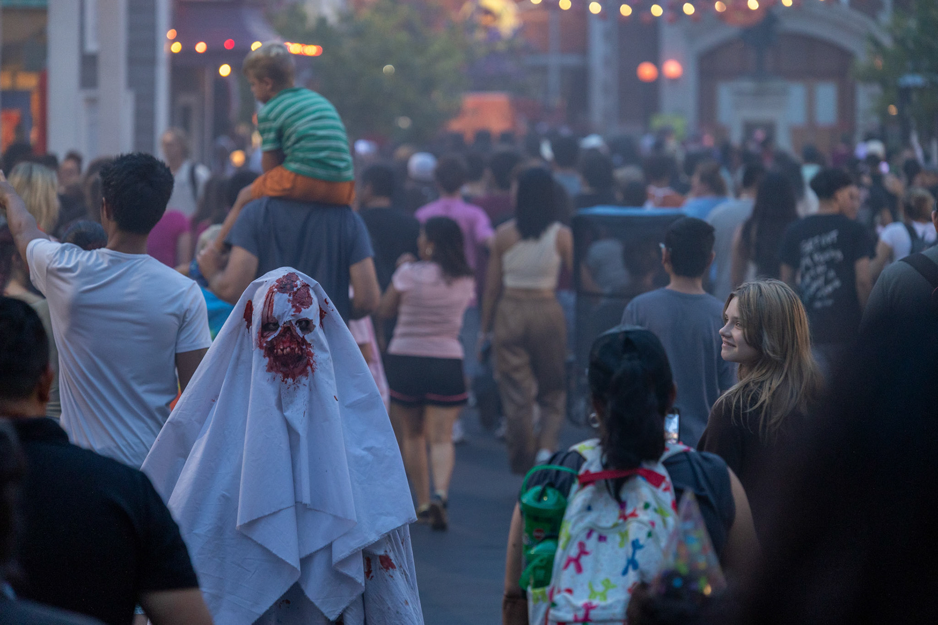 Parkgoers walk through a scare zone on the opening night of Fright Fest at Six Flags Fiesta Texas in San Antonio on Sept. 6, 2025.