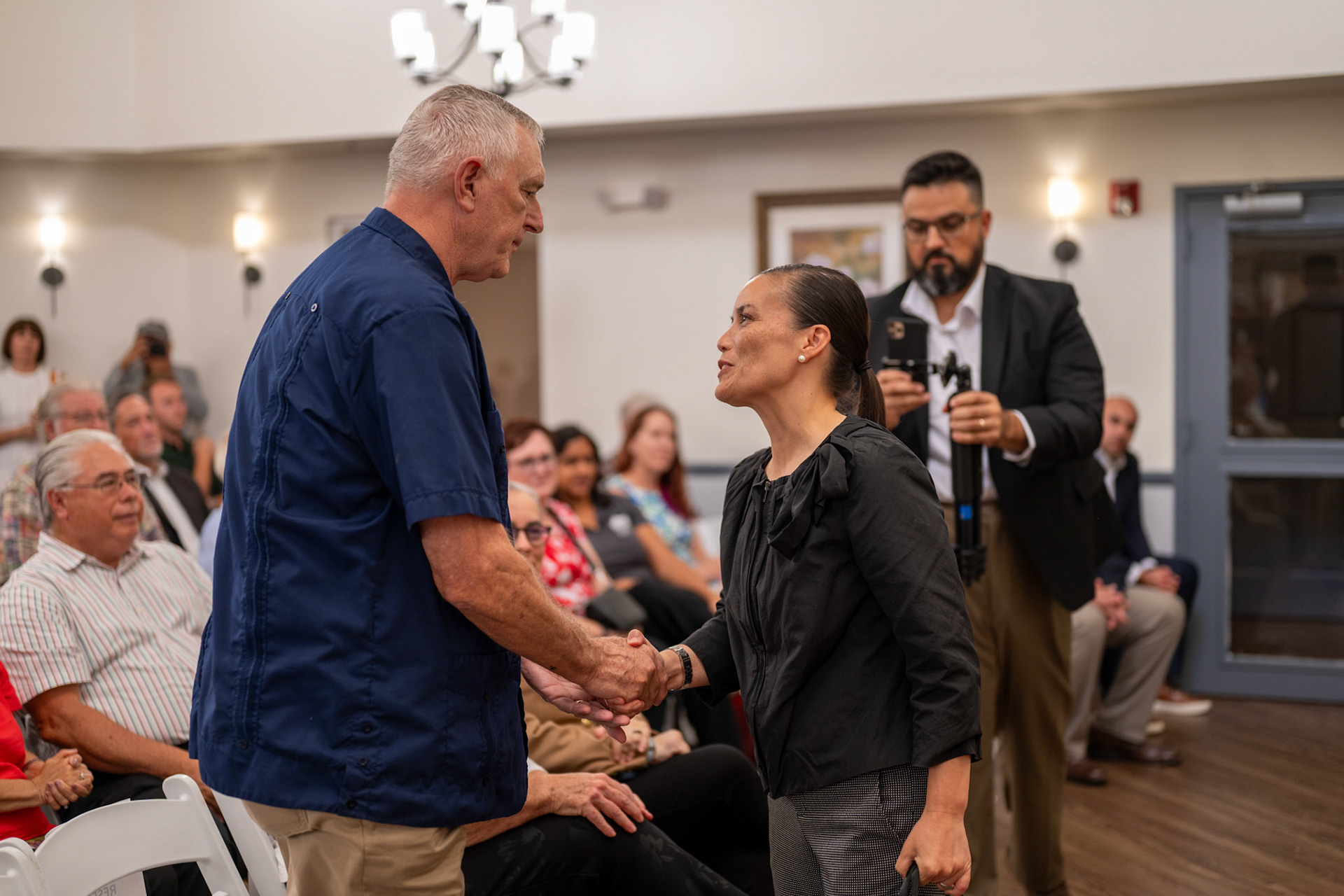 Michael Simpson shakes hands with San Antonio Mayor Gina Ortiz Jones during the ribbon-cutting ceremony for Valor Hill Apartments on Tuesday, July 29, 2025.