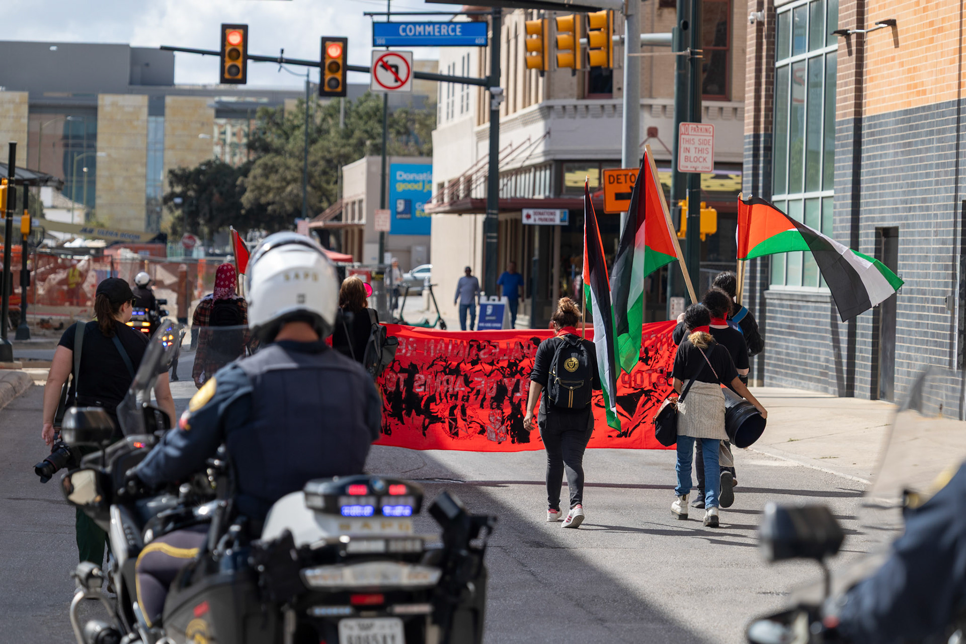 San Antonio Police Department motorcycle patrol units escort members of the Fox Tech Student League as they march through downtown San Antonio during a planned walkout protest on Oct. 7, 2025.