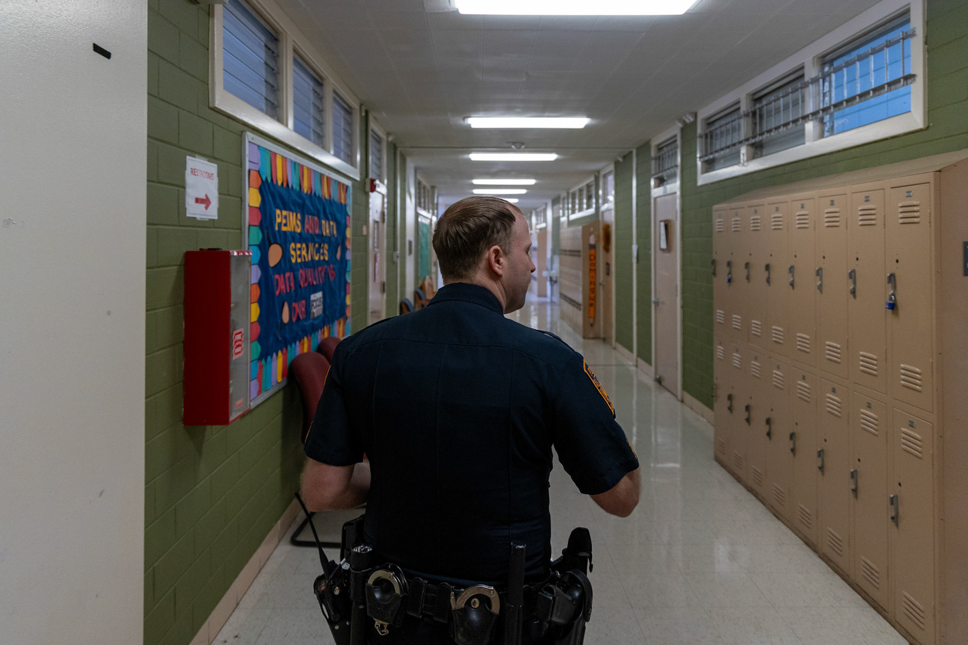 San Antonio Independent School District Police Department Sgt. Joshua Bodenbach walks through the halls of the Copper Learning Center  on Sept. 11, 2025.