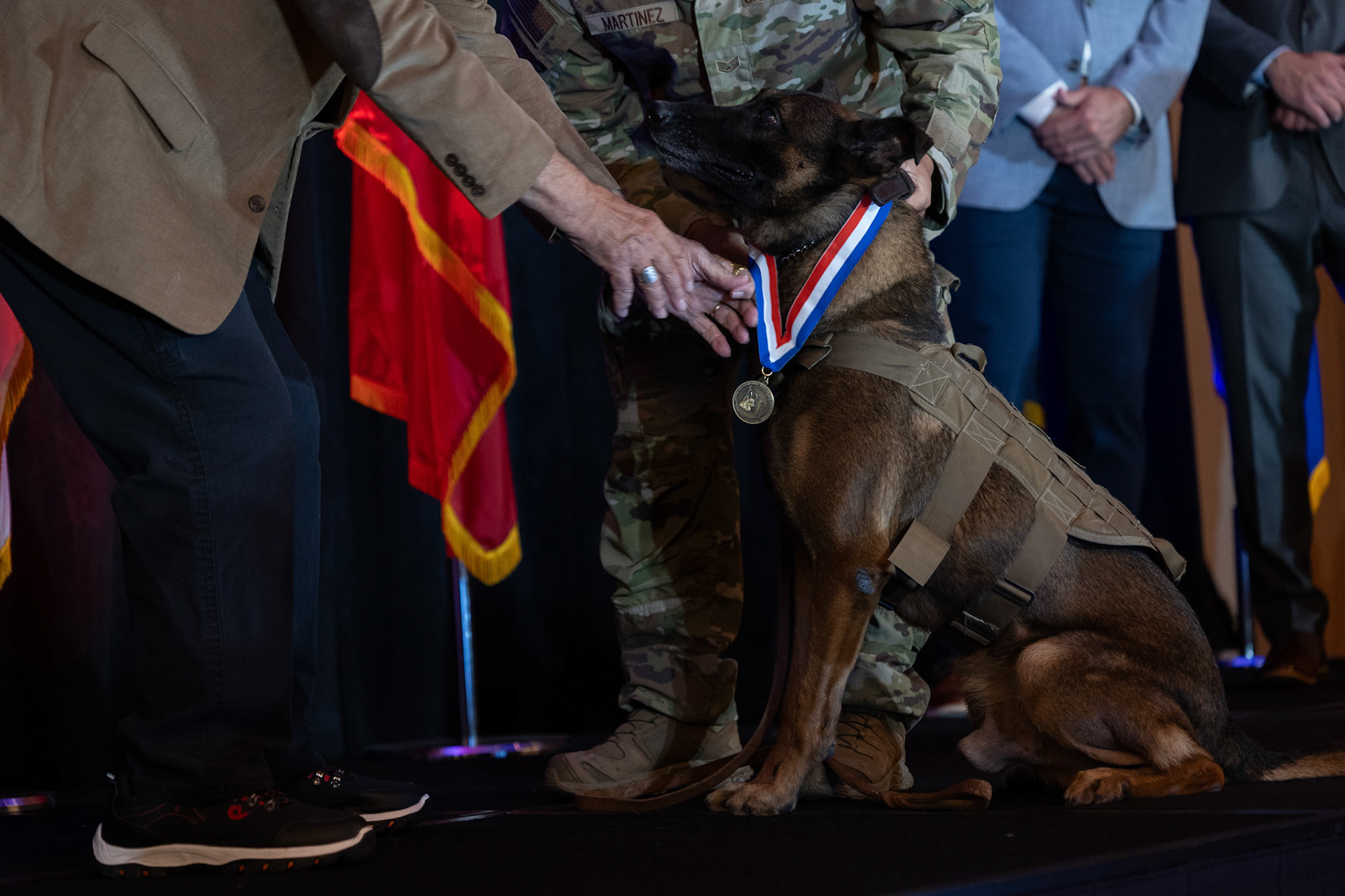 Military working dog Ppuritan receives a medal honoring his retirement from the U.S. Air Force after eight years of service as an explosives detection dog during the U.S. War Dogs Association’s 25th anniversary event Friday, Oct. 17, 2025, at the Plaza San Antonio Hotel &amp; Spa.
