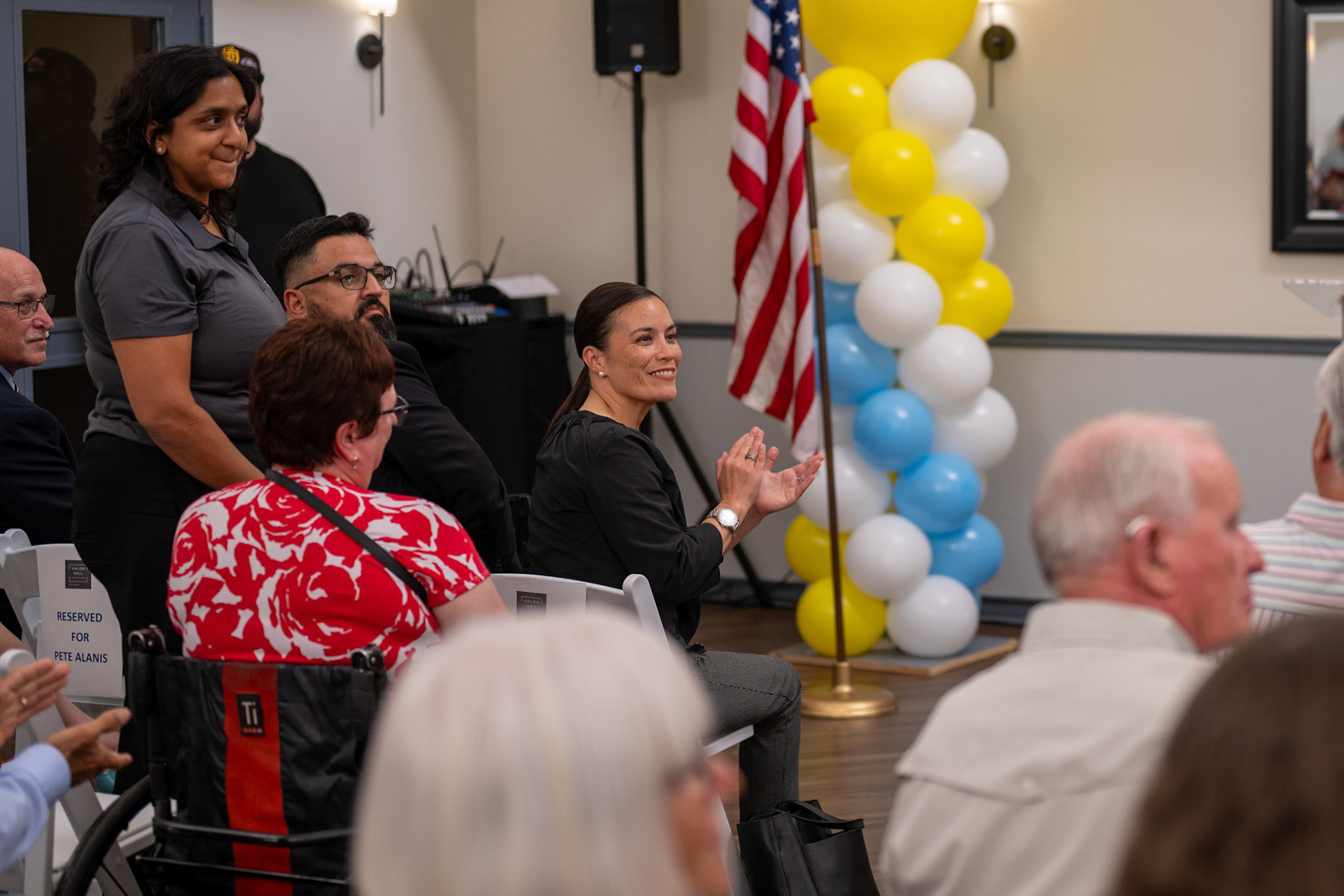 Mayor Gina Ortiz Jones claps for Michael Simpson, father of the fallen soldier the community room is named after, during the Valor Hill Apartments opening ceremony July 29, 2025.